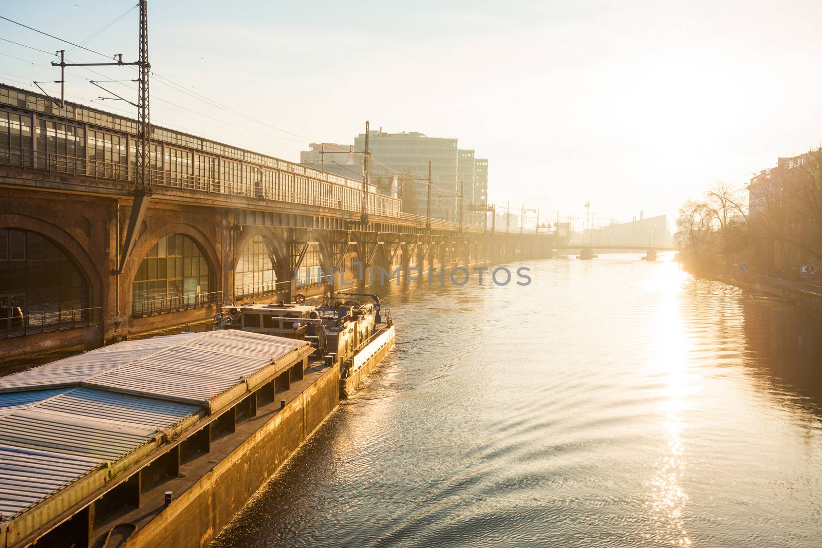 Berlin's River Spree with barge and bright sun