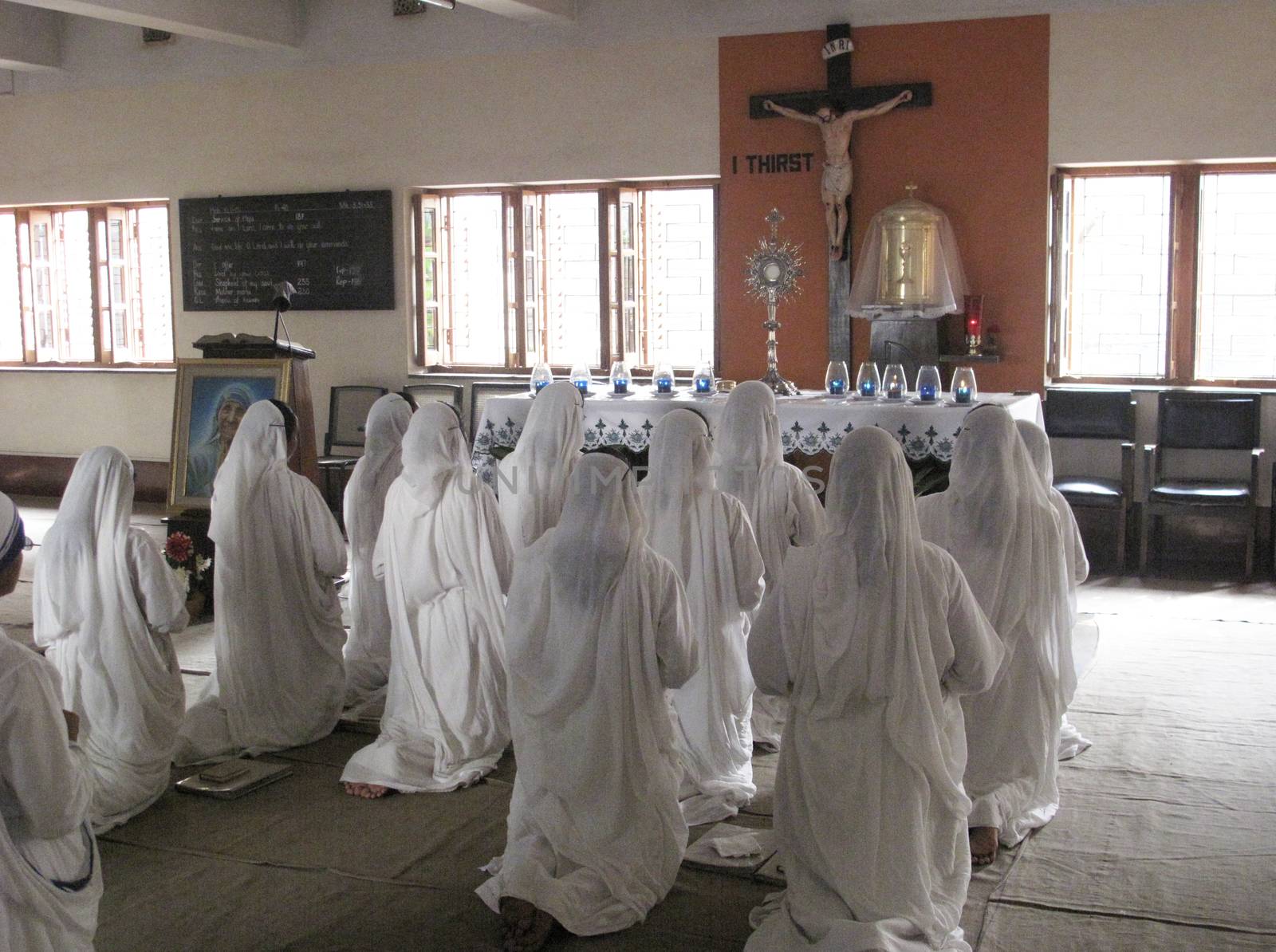 Sisters of Mother Teresa's Missionaries of Charity in prayer in the chapel of the Mother House, Kolkata, India