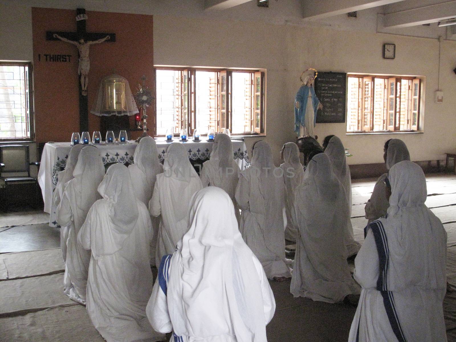 Sisters of Mother Teresa's Missionaries of Charity in prayer in the chapel of the Mother House, Kolkata, India
