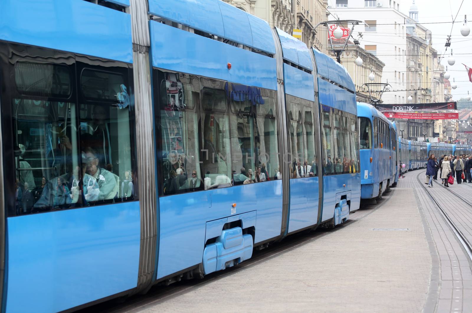 Blue city trams stay in a traffic jam in the city center in Zagreb, Croatia