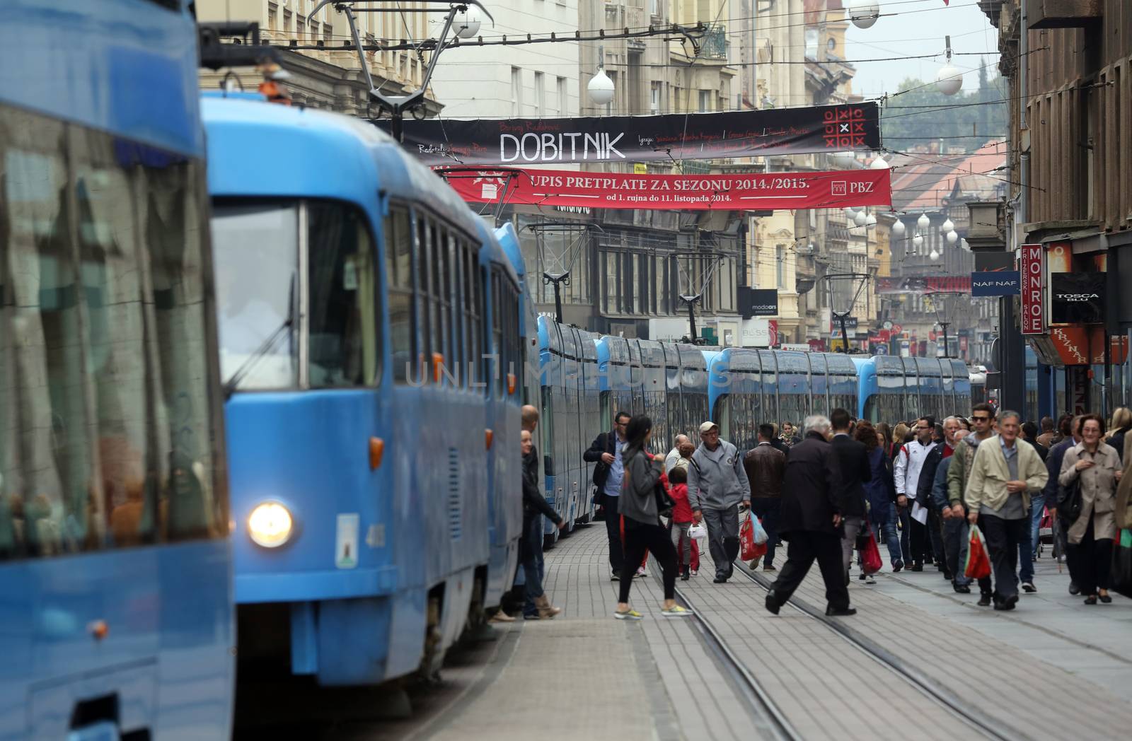 Blue city trams stay in a traffic jam in the city center in Zagreb, Croatia