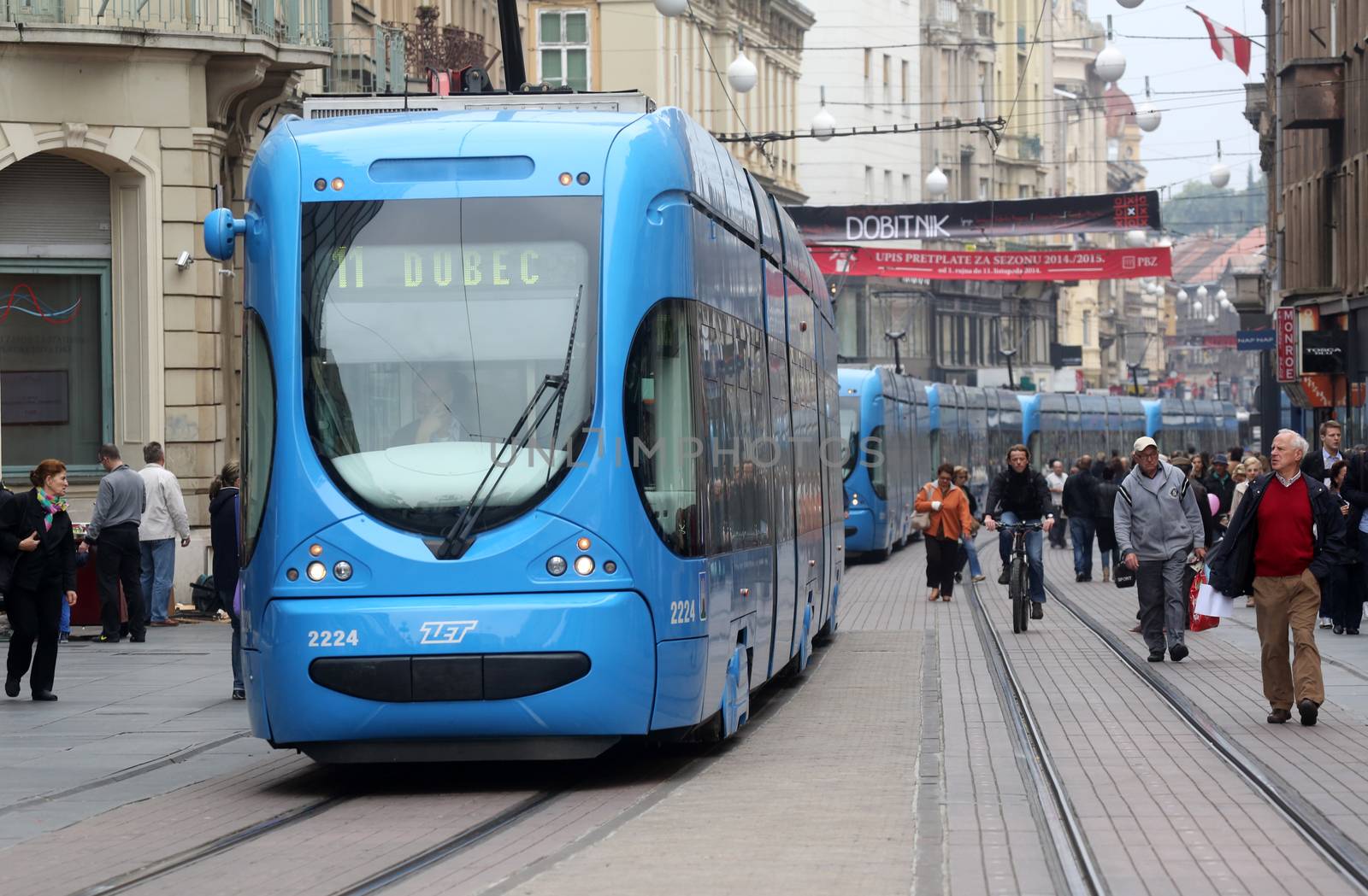Blue city trams stay in a traffic jam in the city center in Zagreb, Croatia