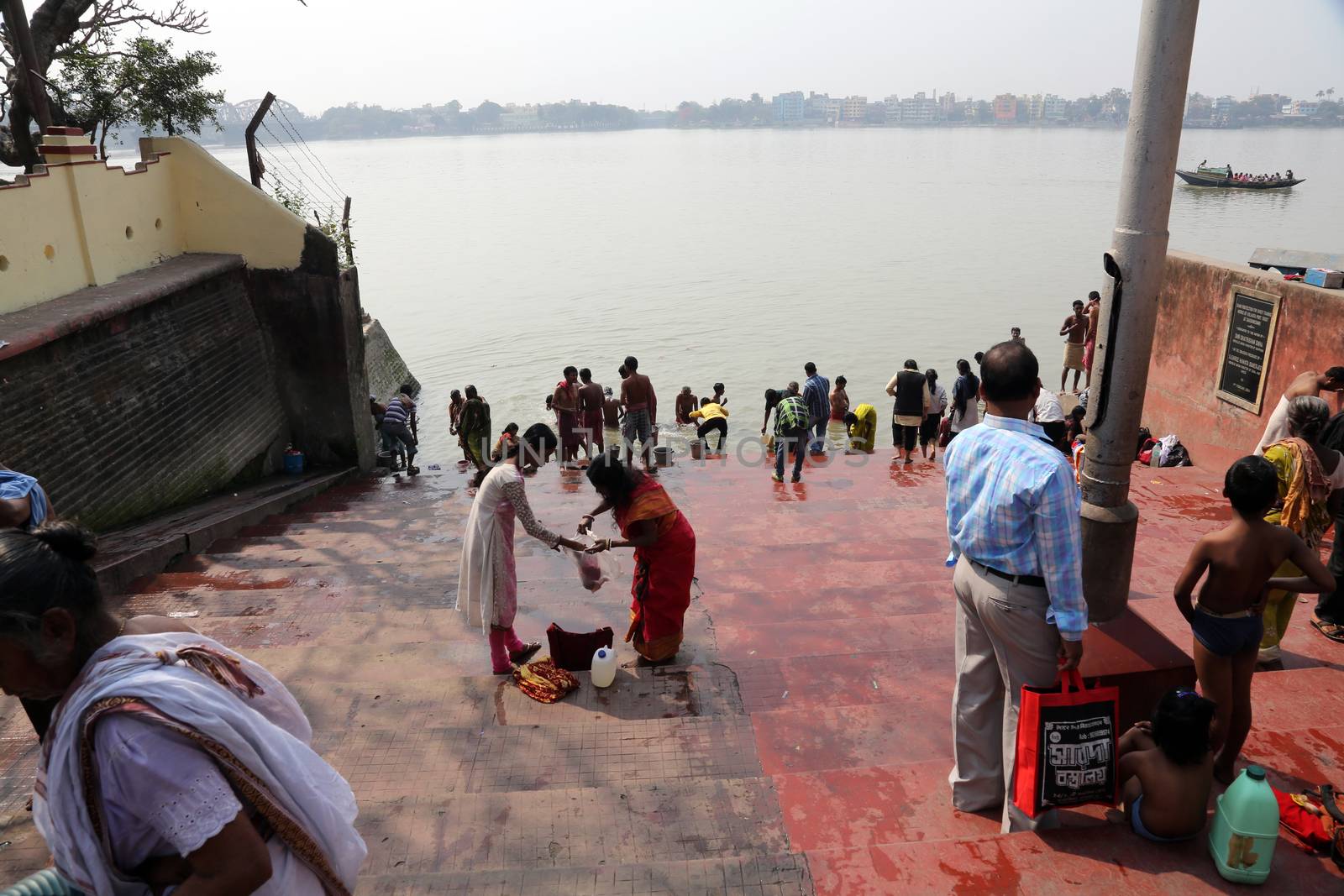 Hindu people bathing in the ghat near the Dakshineswar Kali Temple in Kolkata, West Bengal, India