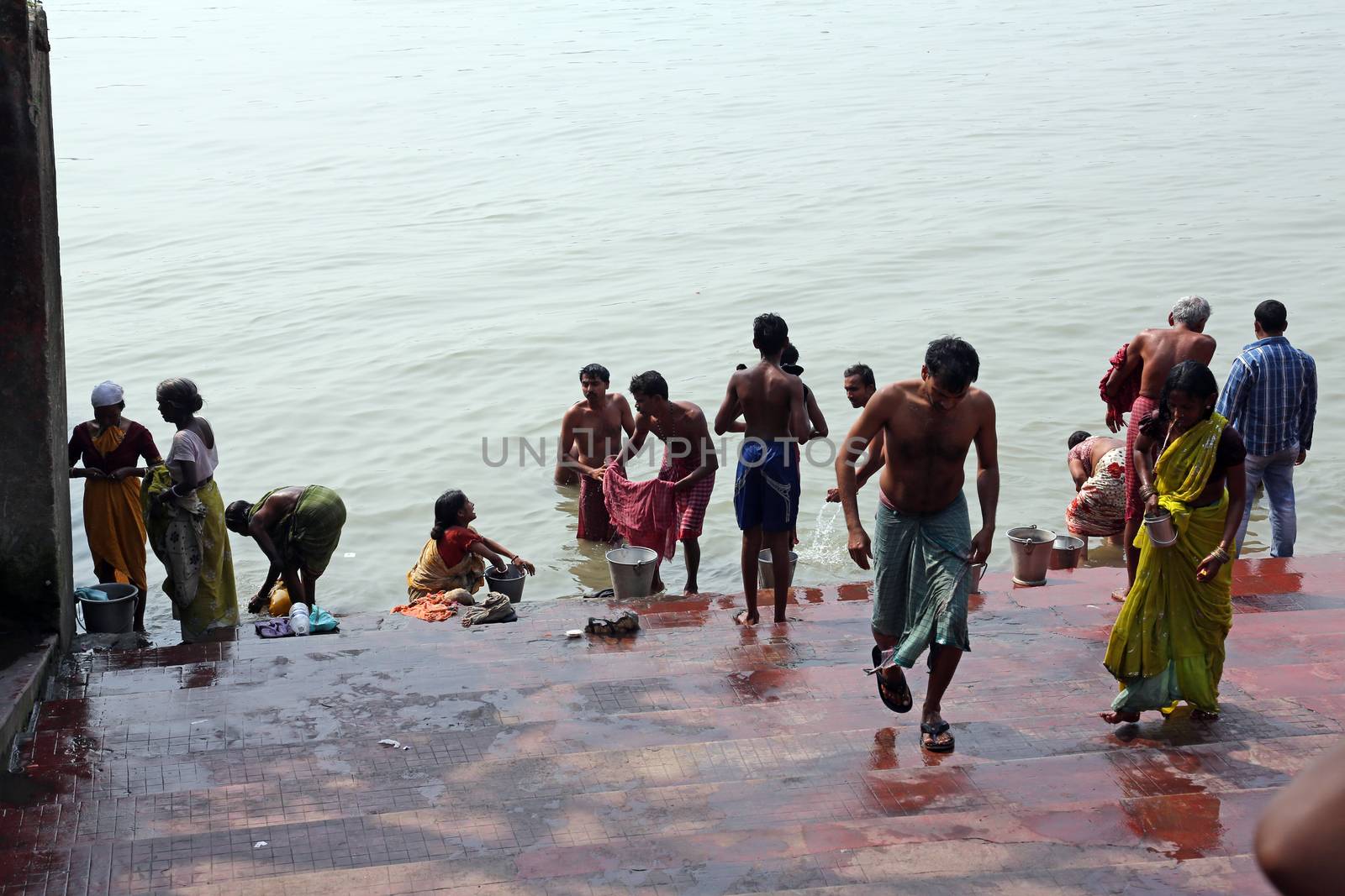 Hindu people bathing in the ghat near the Dakshineswar Kali Temple in Kolkata, West Bengal, India