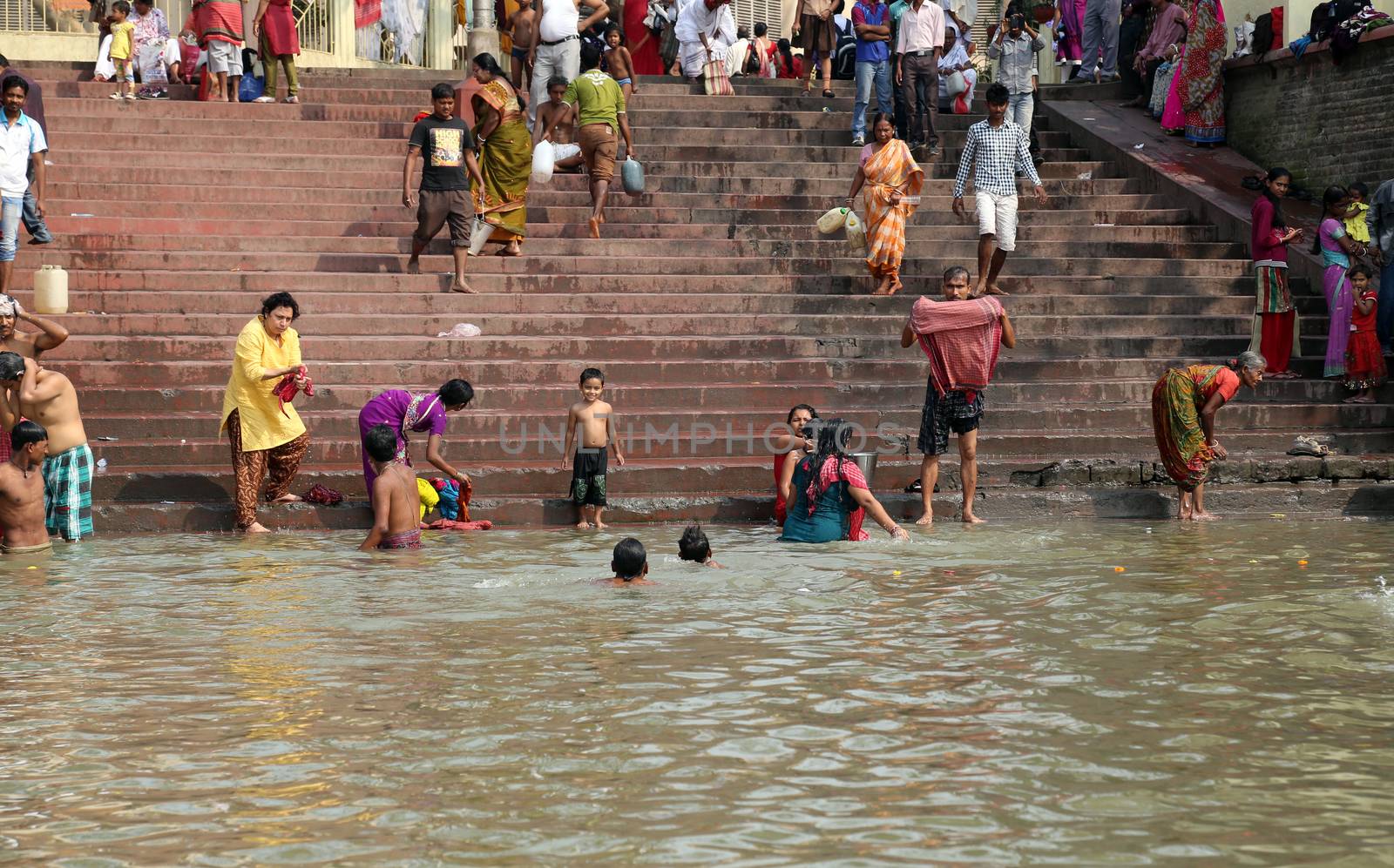 Hindu people bathing in the ghat near the Dakshineswar Kali Temple in Kolkata, West Bengal, India