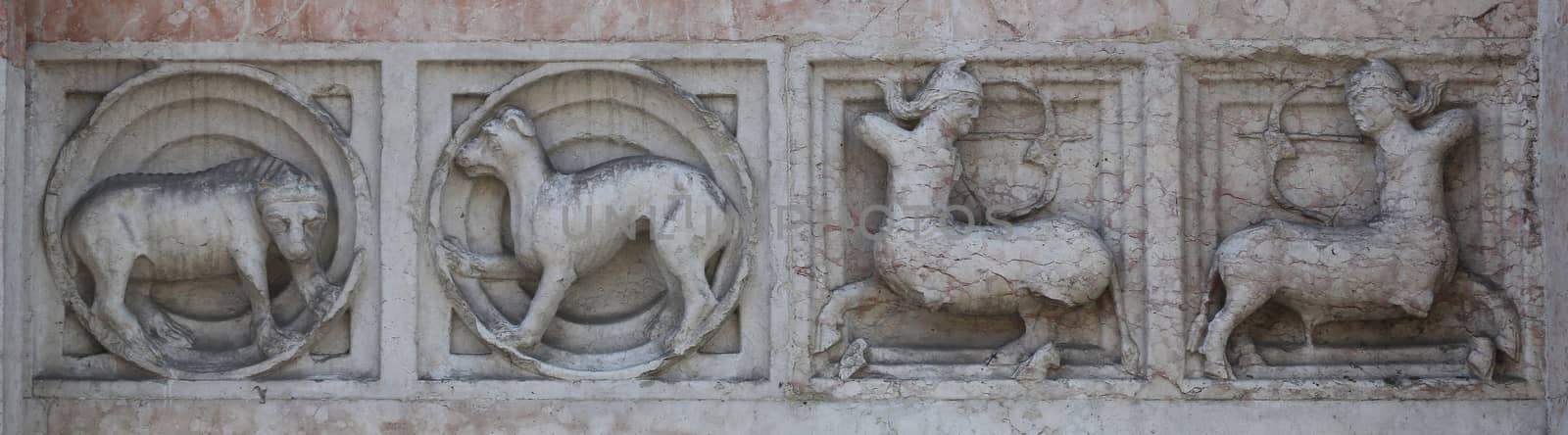 Detail of some marble medieval bas relief outside the Baptistery in Parma, Italy by atlas