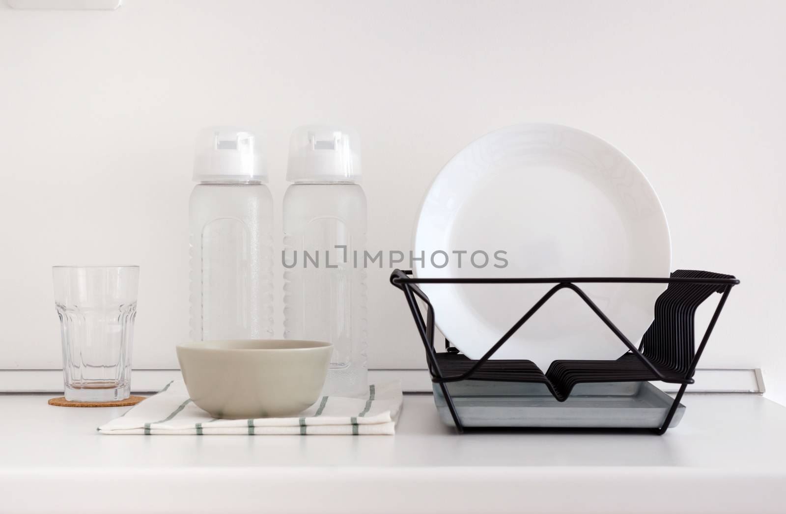 Utensil on white top counter in kitchen by siraanamwong