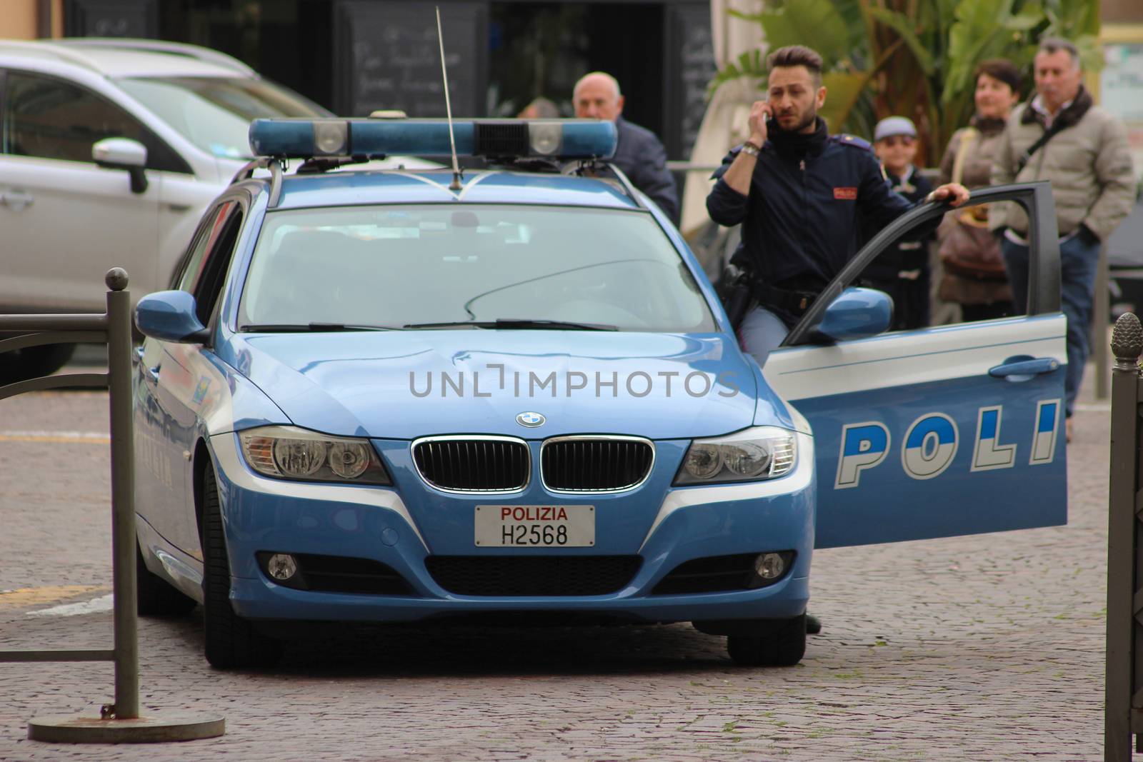 San Remo, Italy - March 20, 2016: Italian Policeman with a BMW car in the Streets of San Remo. City on the Mediterranean Coast of western Liguria in north-western Italy