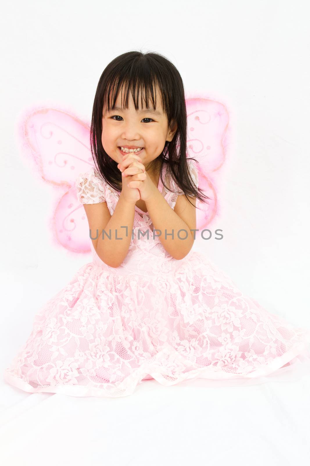 Chinese little girl wearing butterfly custome with praying gestu by kiankhoon