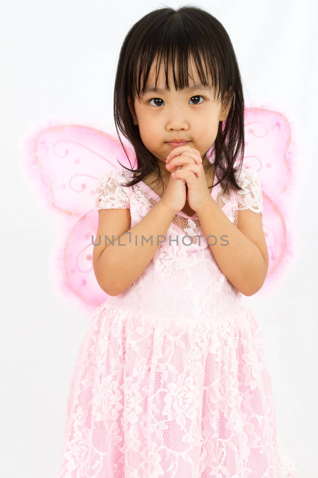 Chinese little girl wearing butterfly custome with praying gestu by kiankhoon