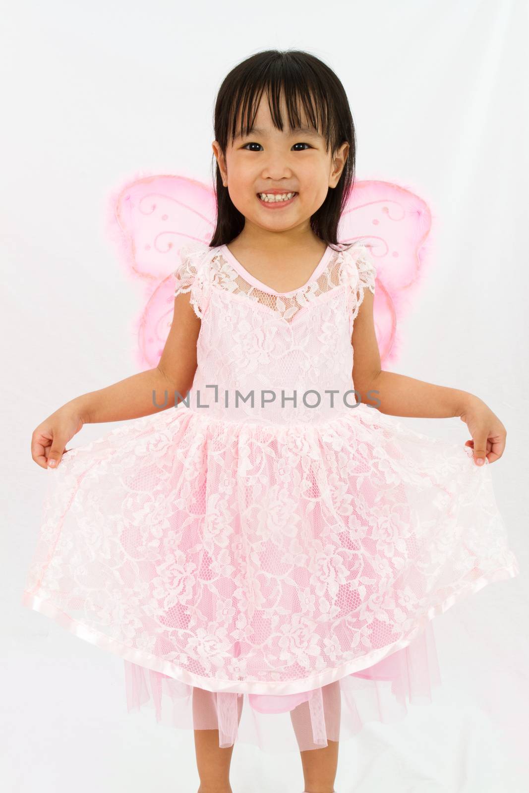 Chinese little girl wearing butterfly custome in plain white background