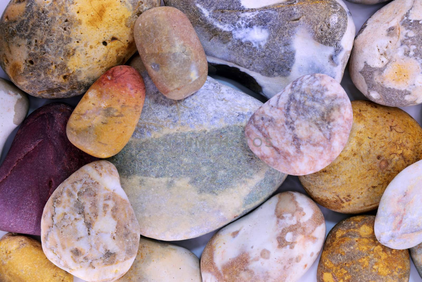 Pebbles from beach sites around the UK in arrangements.