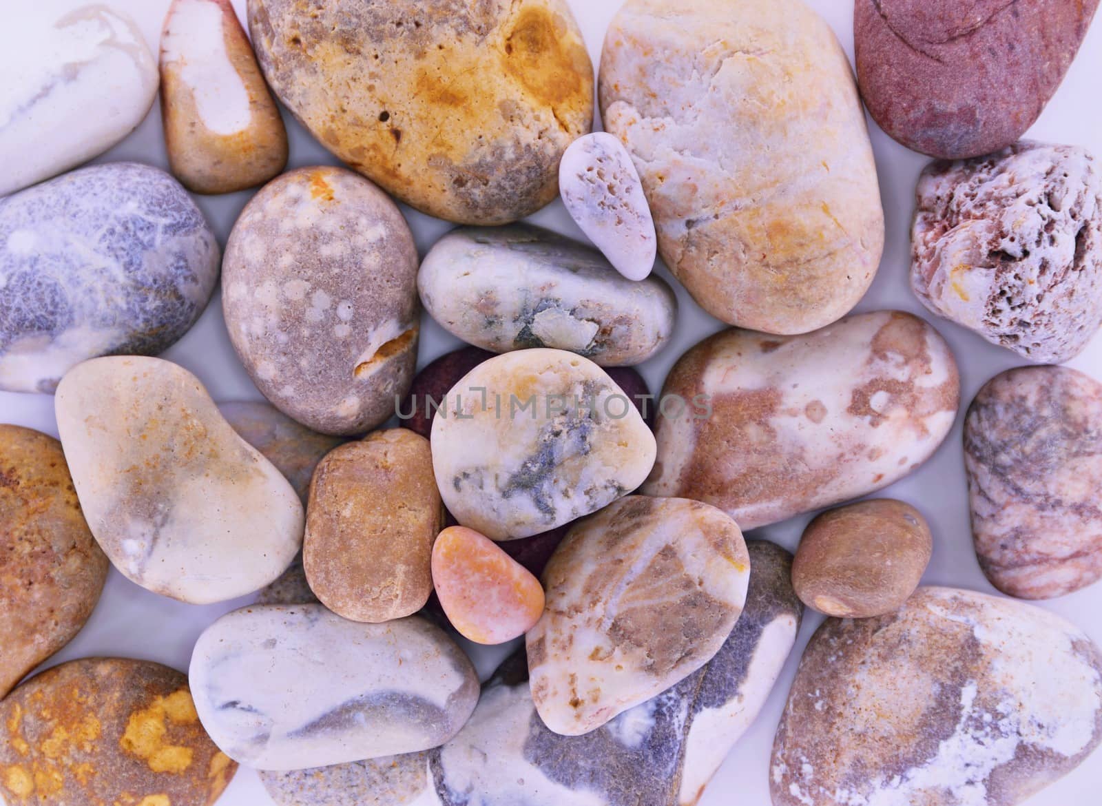 Pebbles from beach sites around the UK in arrangements.