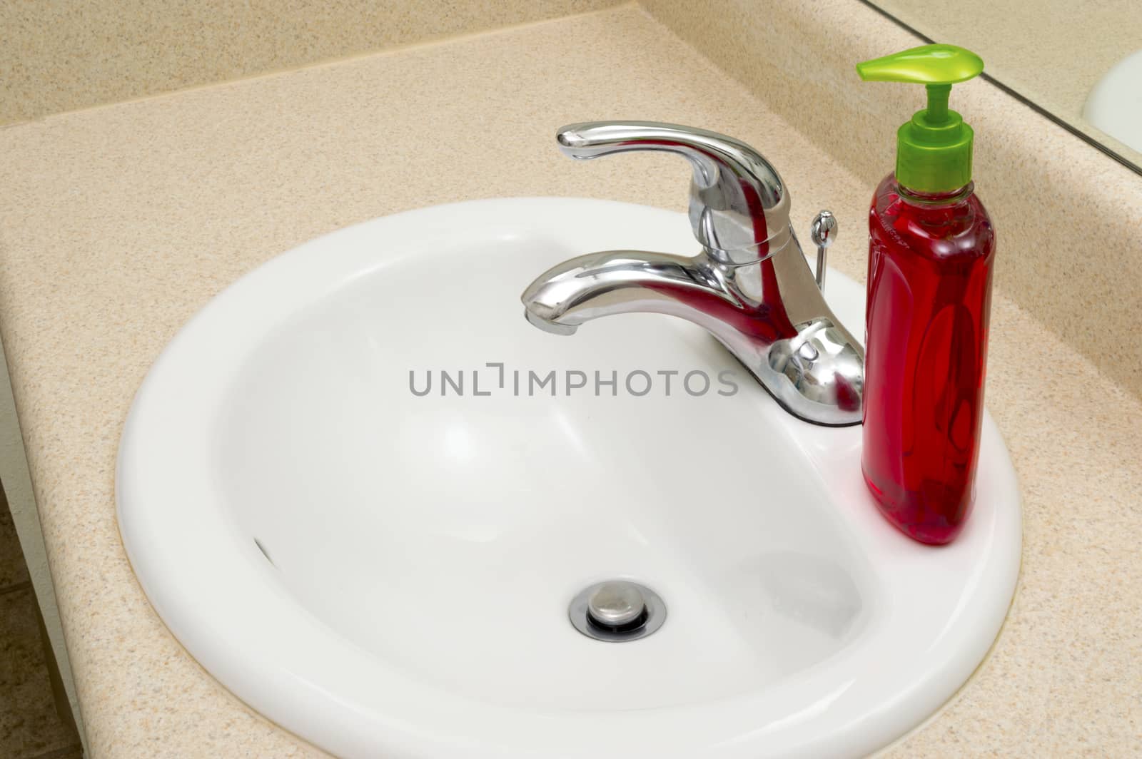 Sink With Liquid Soap In Bathroom by stockbuster1