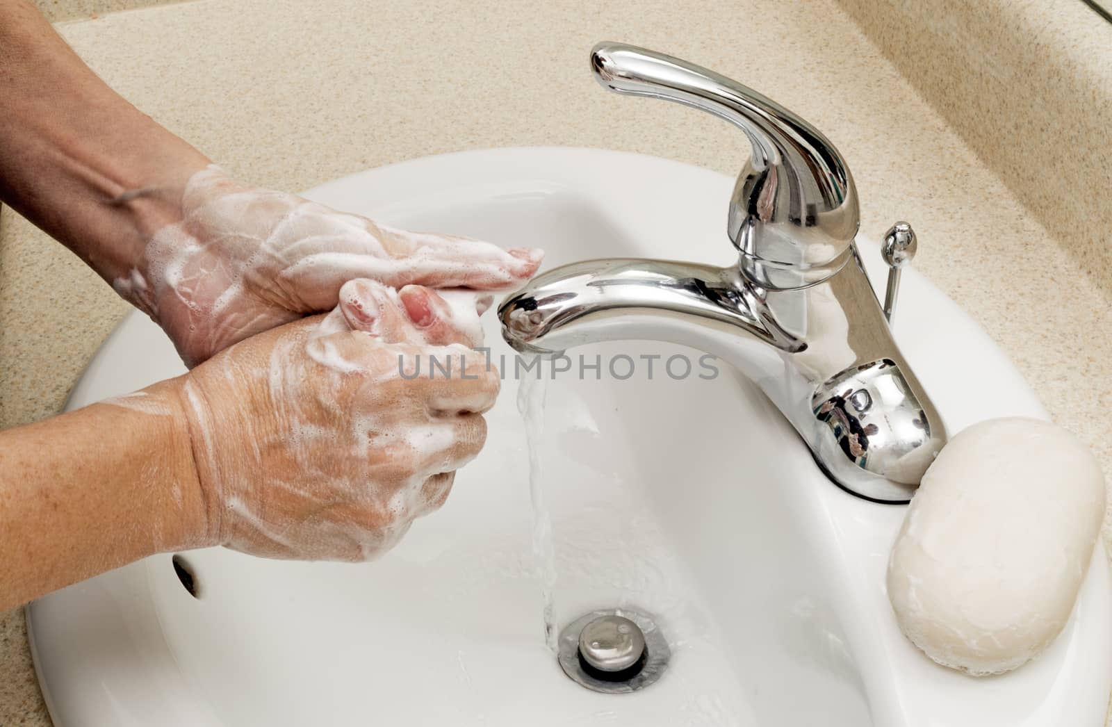 Showing good hygiene, a woman washes her hands.