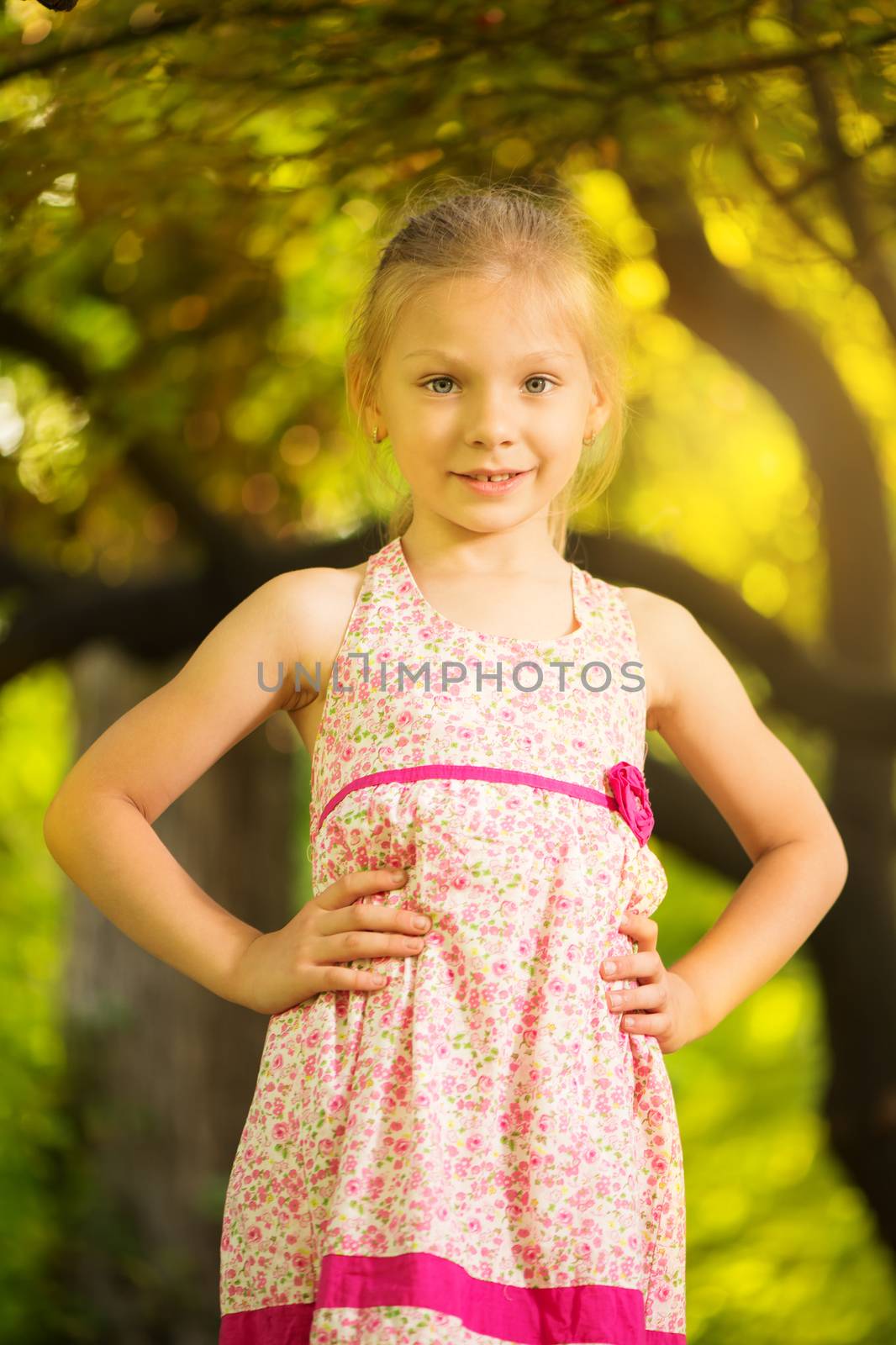 Cute little girl having fun on the tree in the park