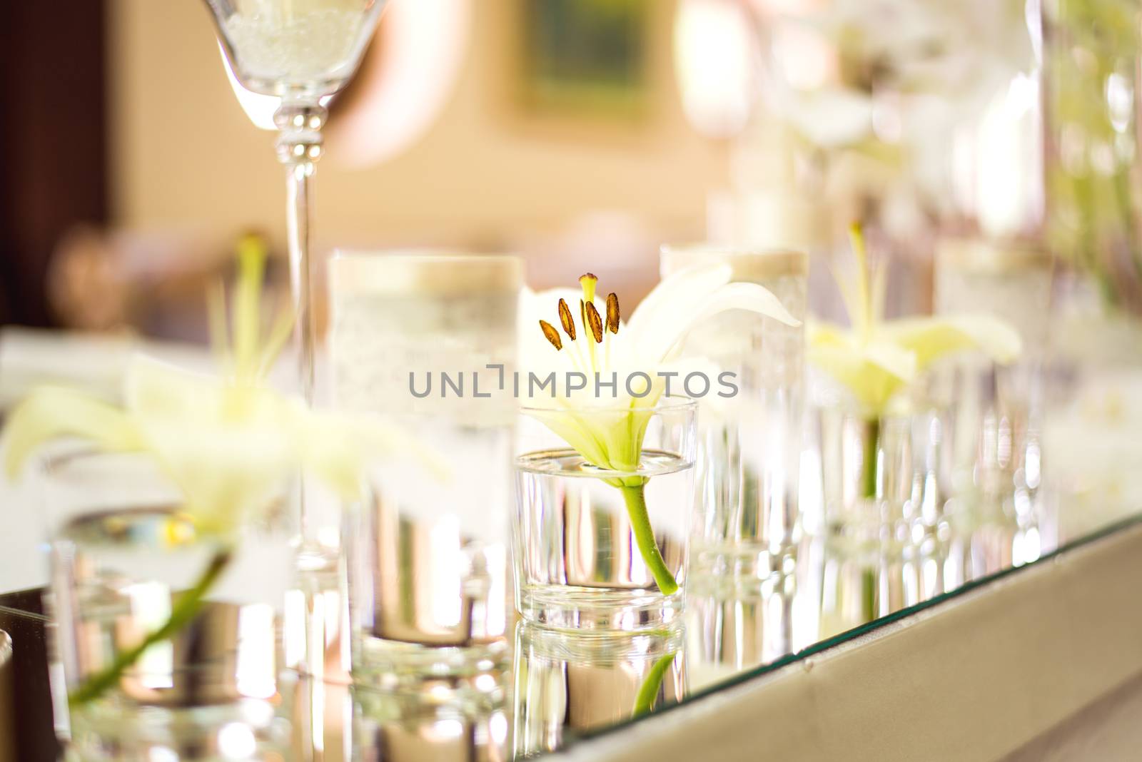 Wedding table decoration with flowers, candle and glassware
