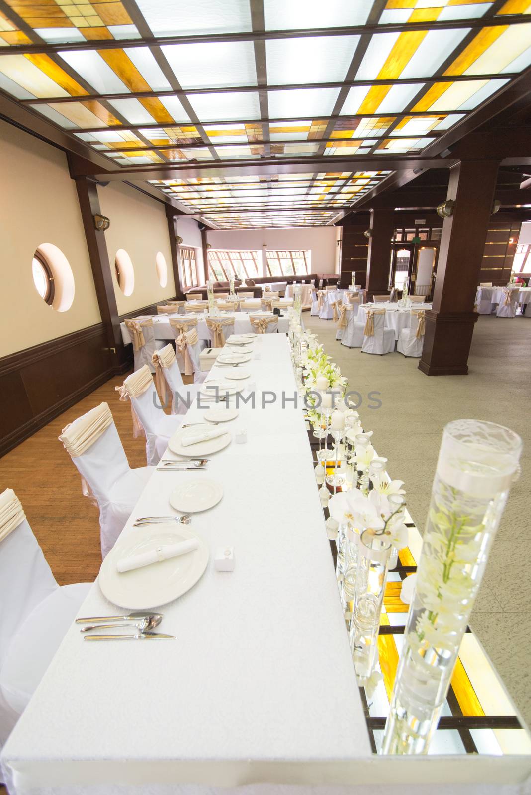Wedding table decoration with candle, flowers and glassware