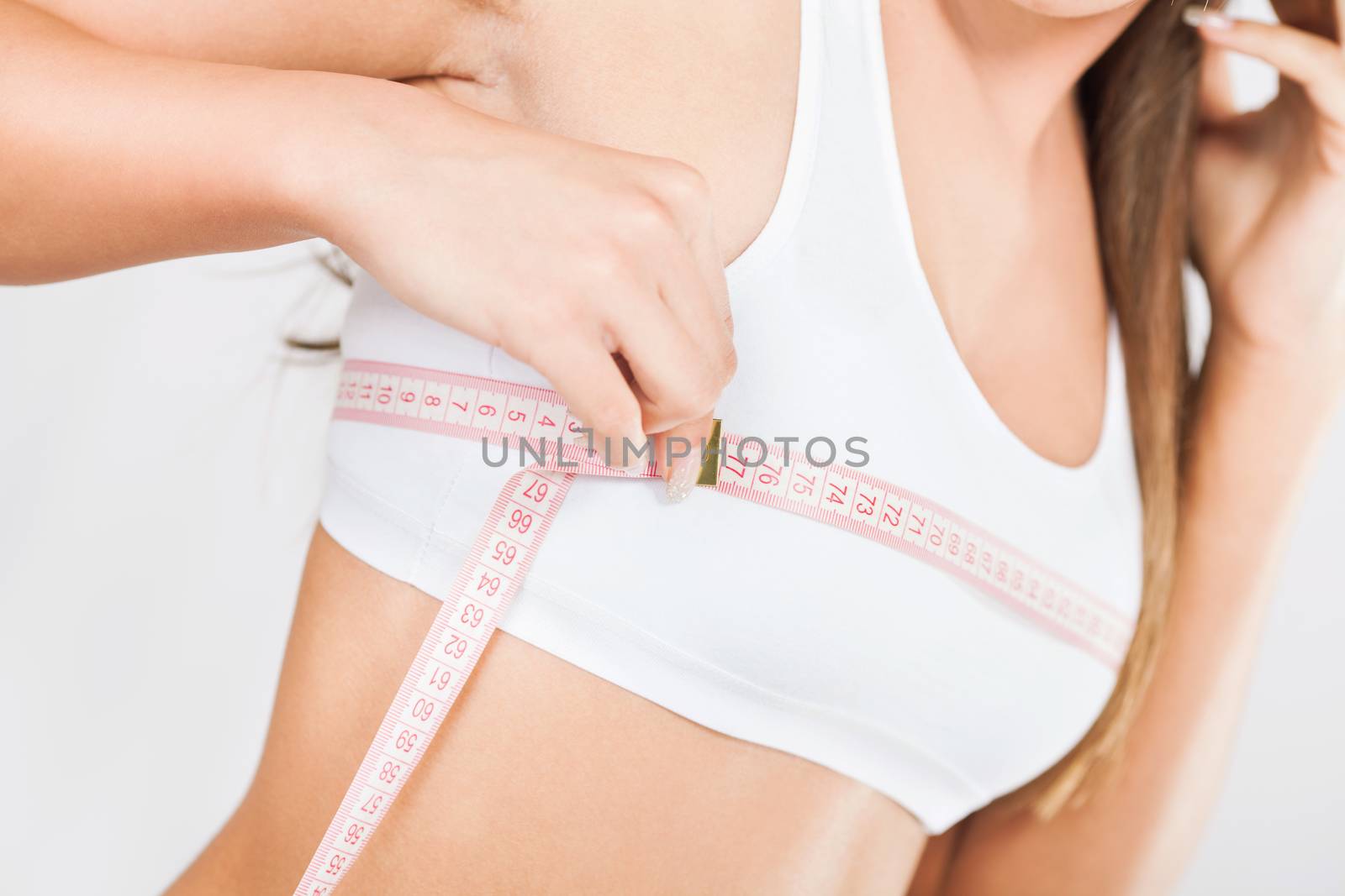 Beautiful young girl measuring the girth of chest.