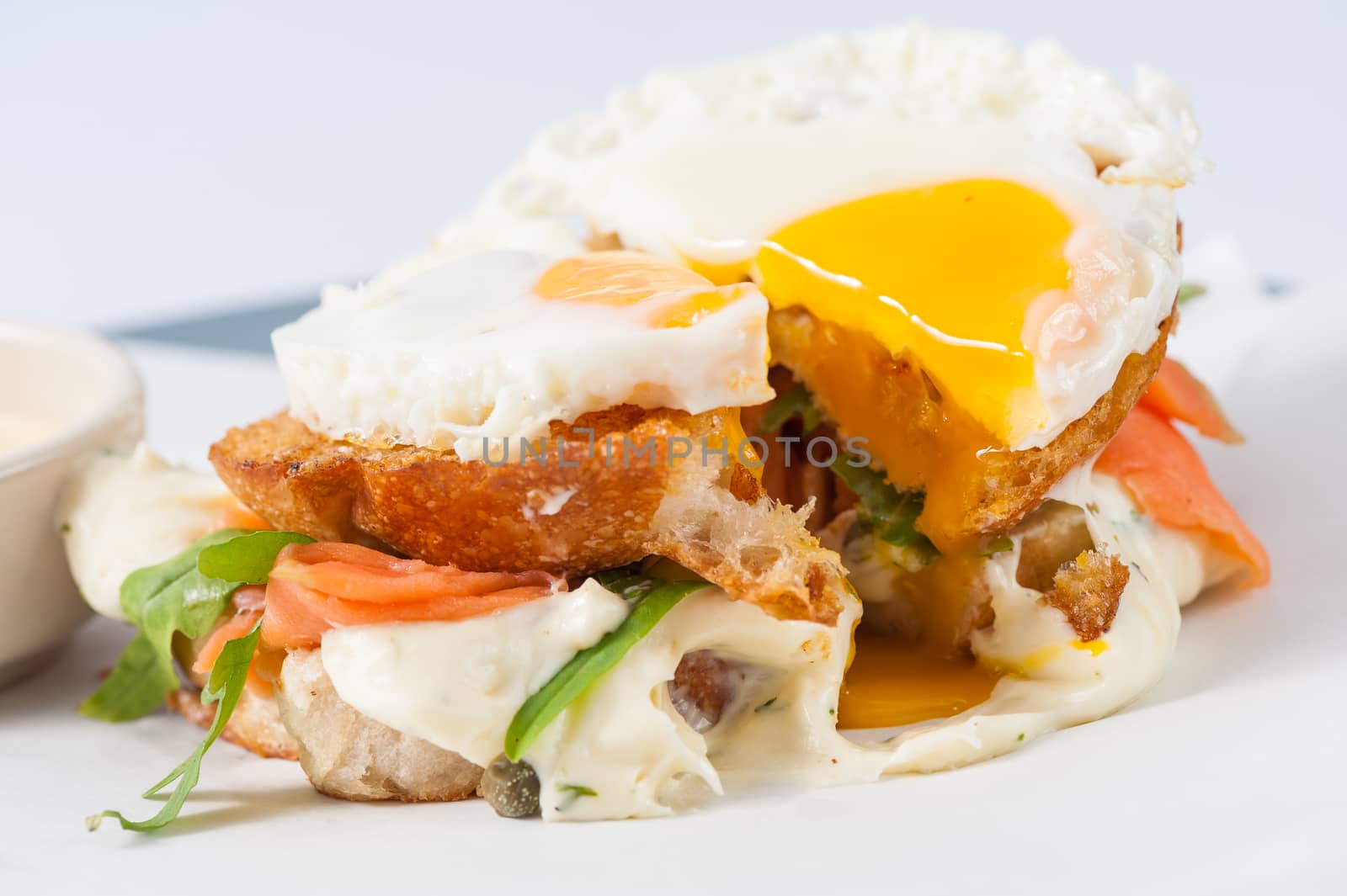 Close up scene of grilled sandwich with bacon and fried egg