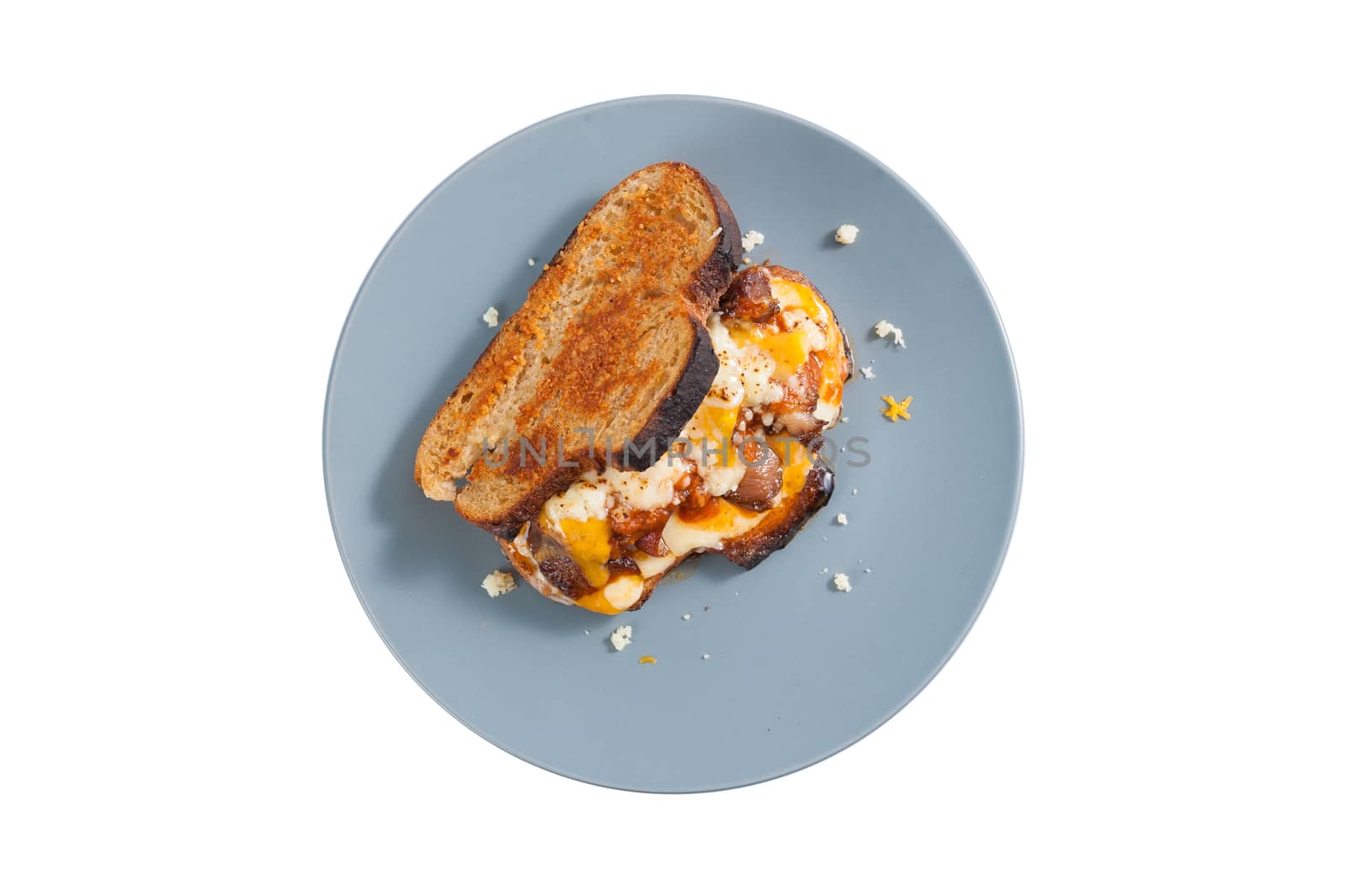 Toasted sandwich with chicken and various types of  cheese in ceramic dish isolated on white background with clipping path.