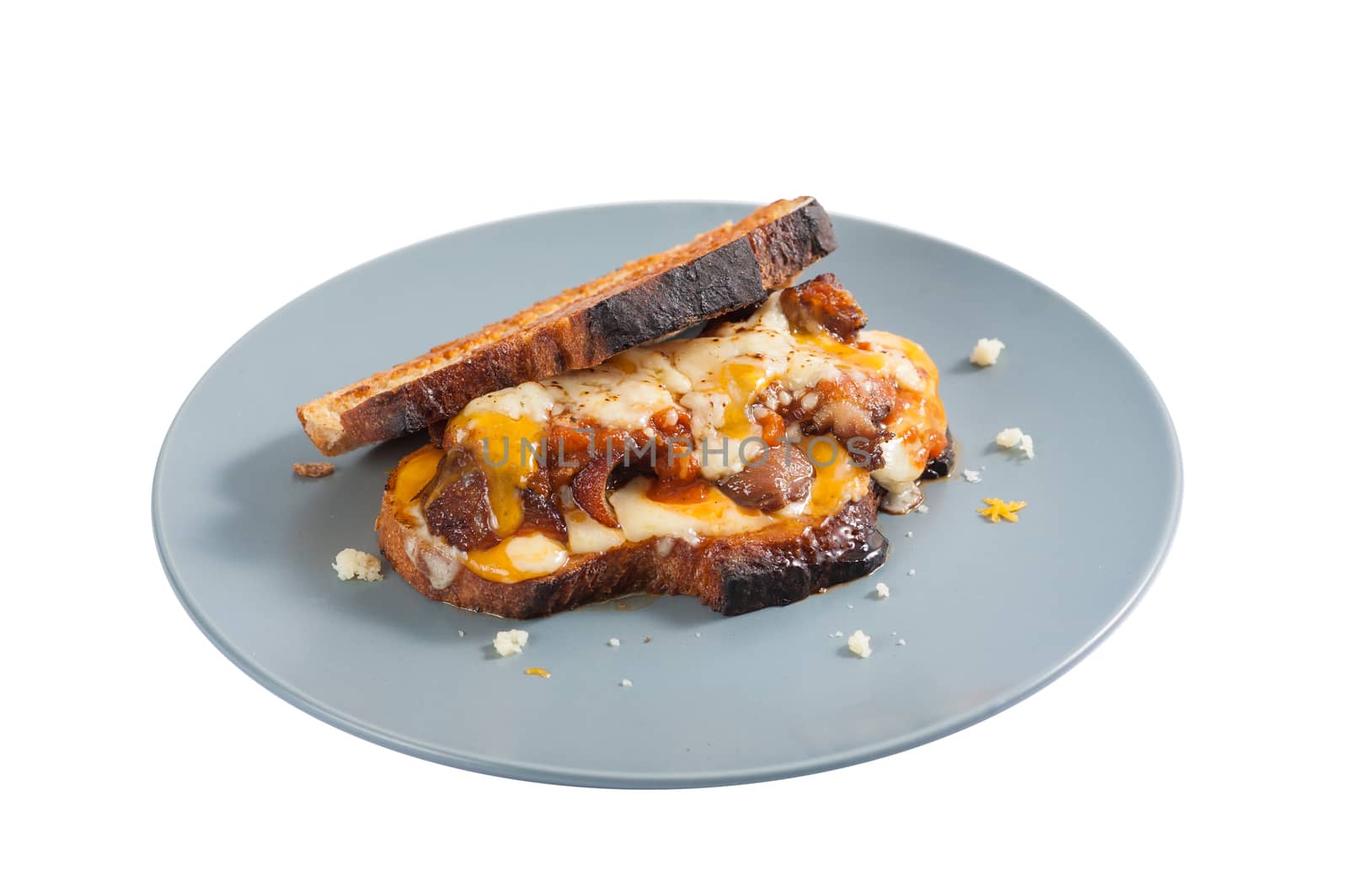 Toasted sandwich with chicken and various types of  cheese in ceramic dish isolated on white background with clipping path.