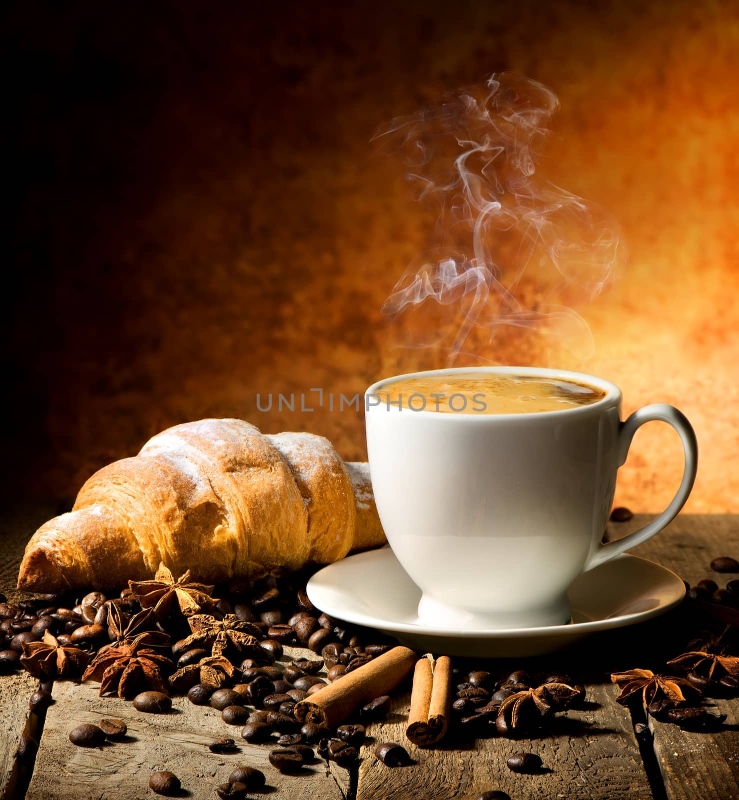 Fresh croissant and coffee with spices on table