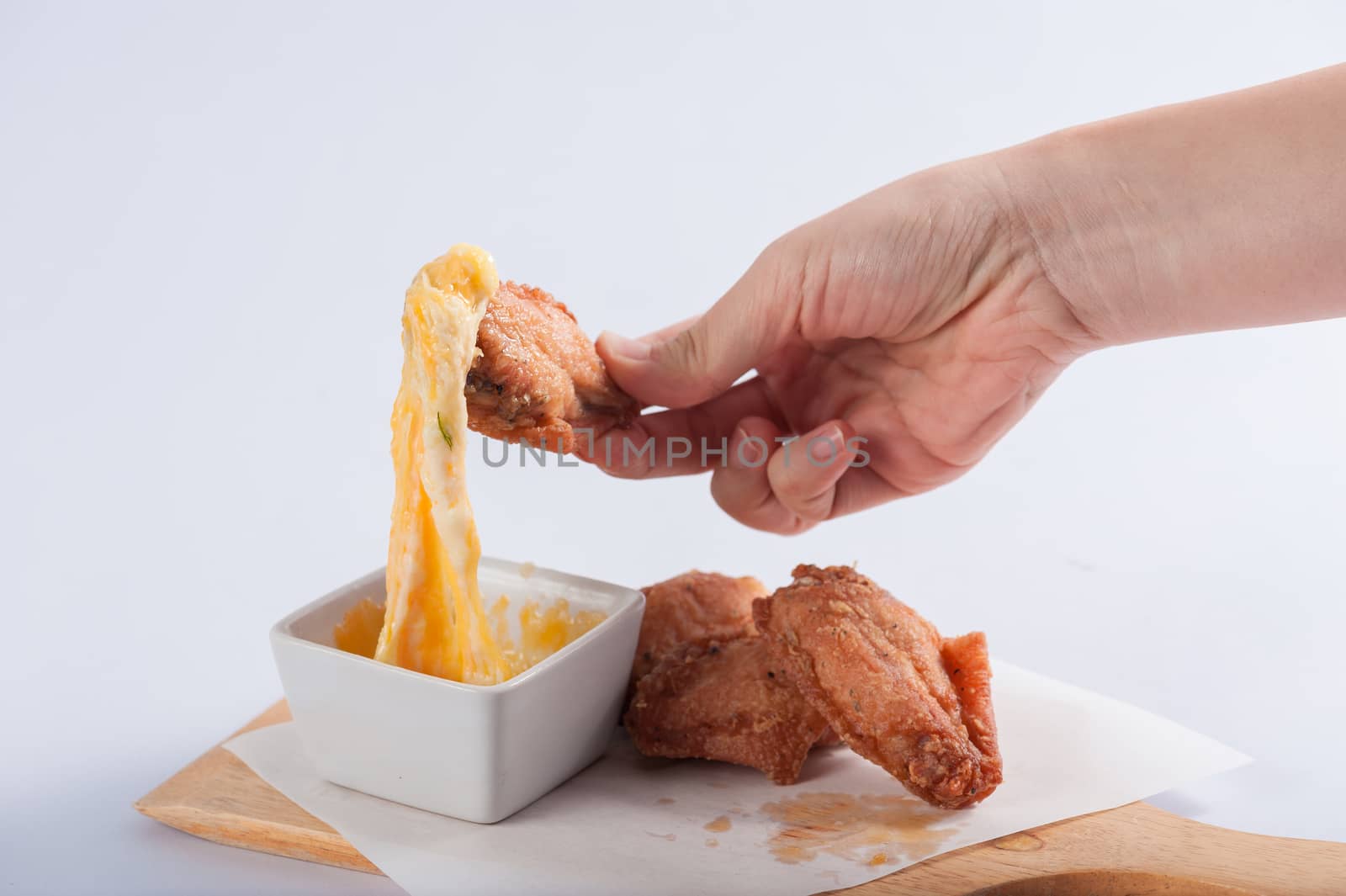 Deep fried chicken wings with various types of cheese for dipping.