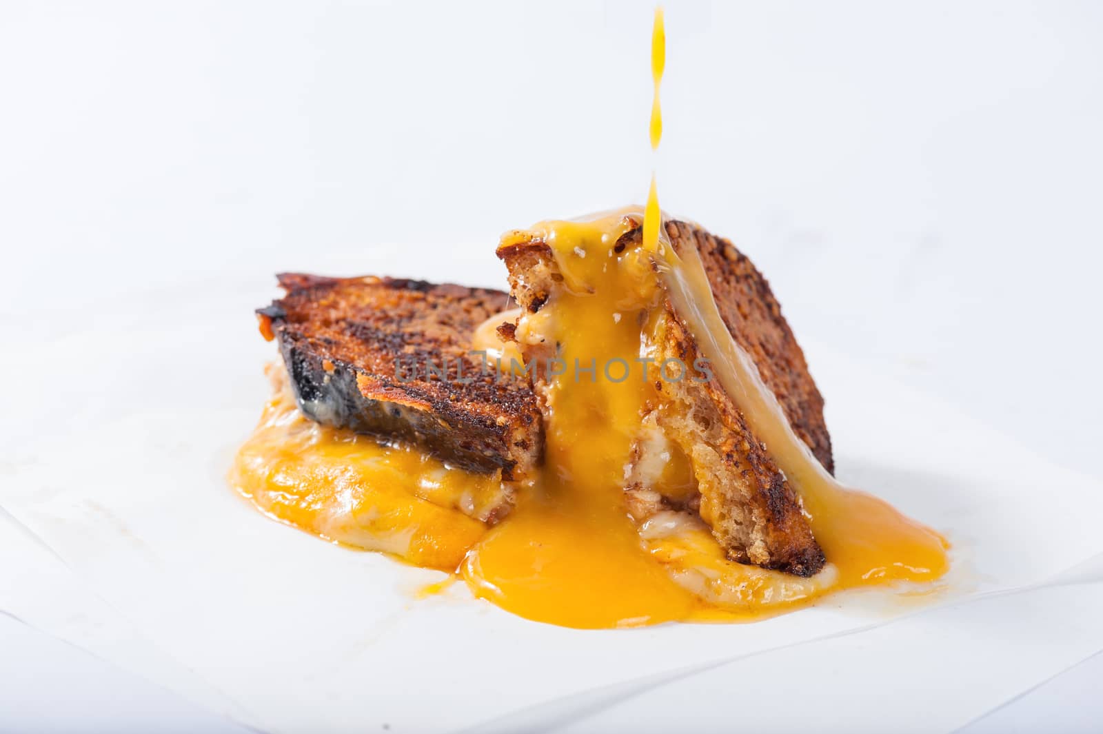 Toasted sandwich with various types of  cheese dressed with mango sauce