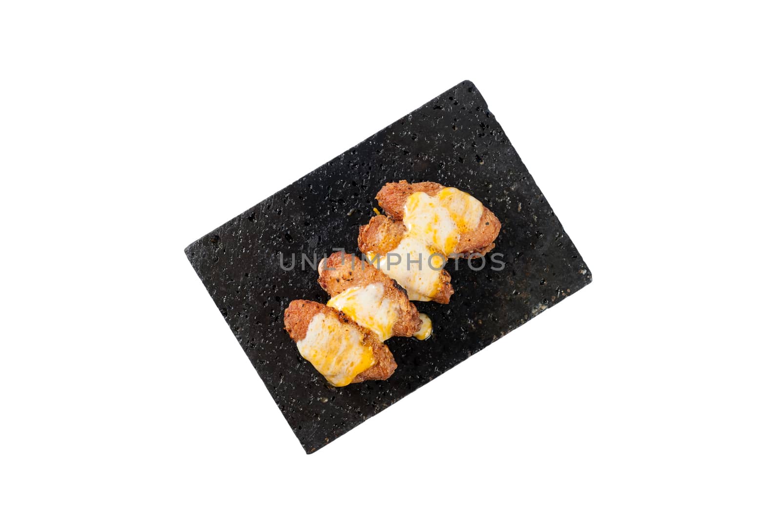 Deep fried chicken wings dressed with various types of cheese on black stone plate isolated on white background with clipping path