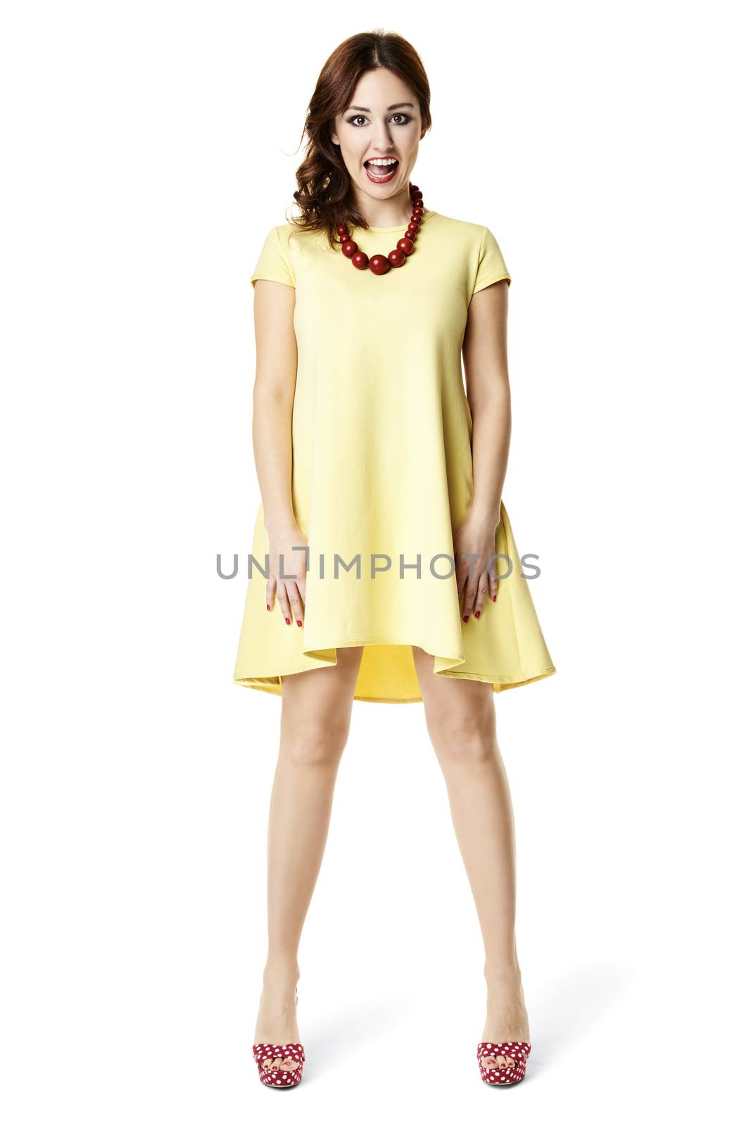 Studio shot of young woman in yellow dress.