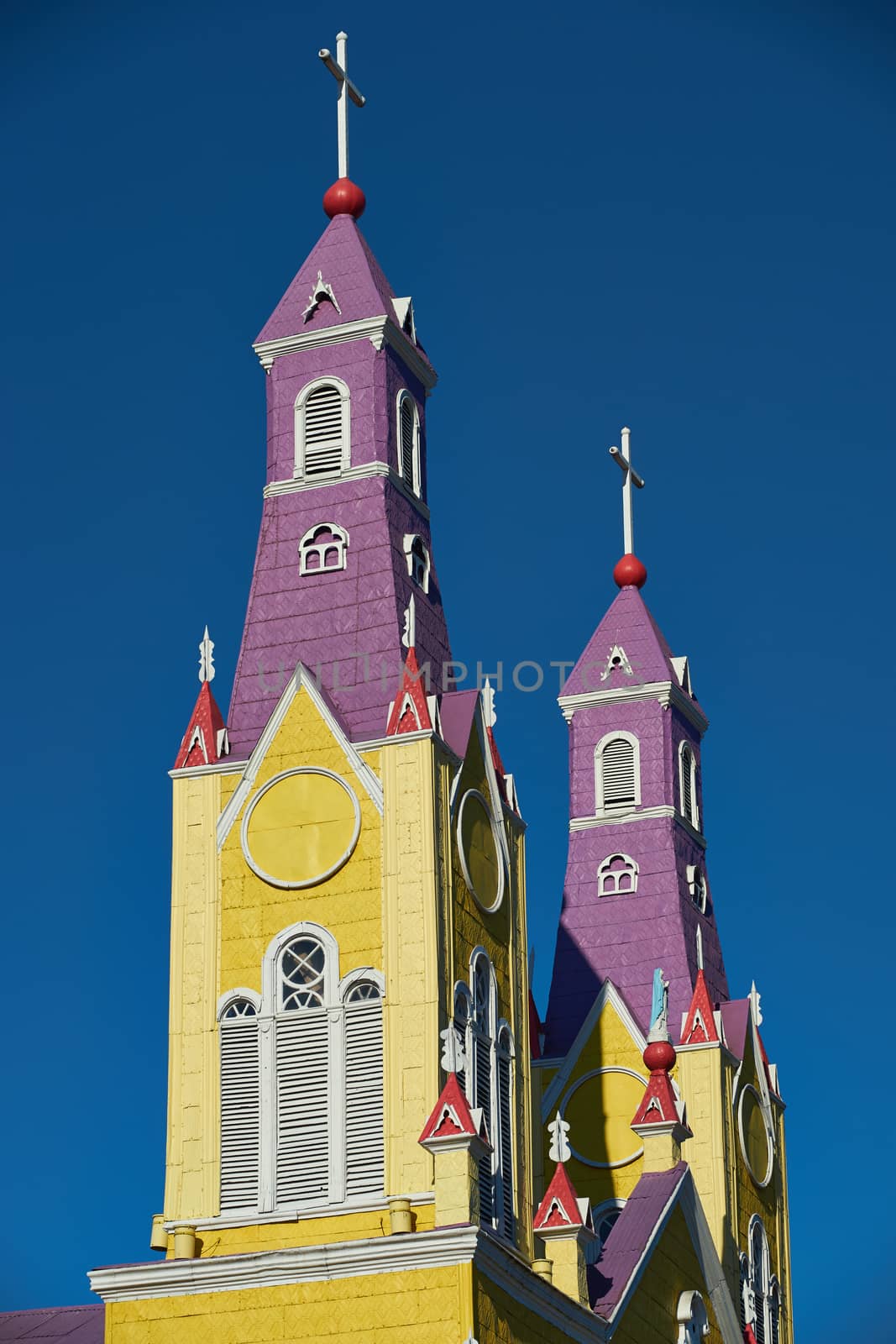 Bright yellow and purple painted facade of the historic Iglesia San Francisco in Castro, capital of the island of Chiloé in Chile.