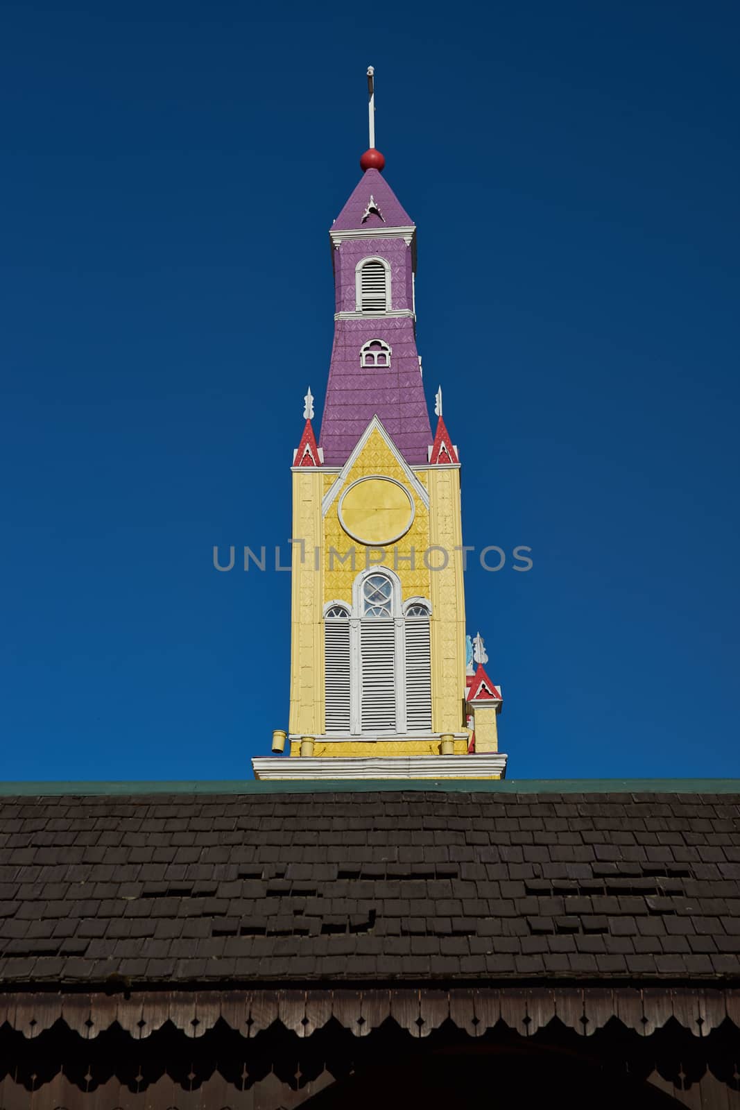 Bright yellow and purple painted facade of the historic Iglesia San Francisco in Castro, capital of the island of Chiloé in Chile.