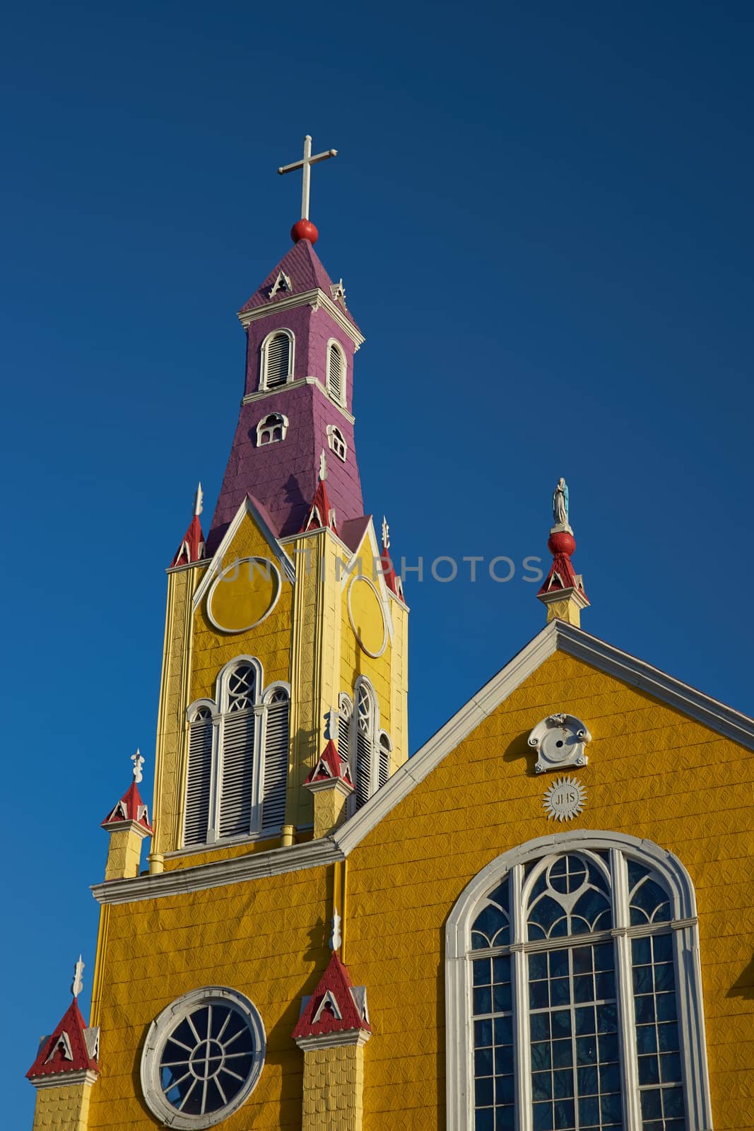 Bright yellow and purple painted facade of the historic Iglesia San Francisco in Castro, capital of the island of Chiloé in Chile.