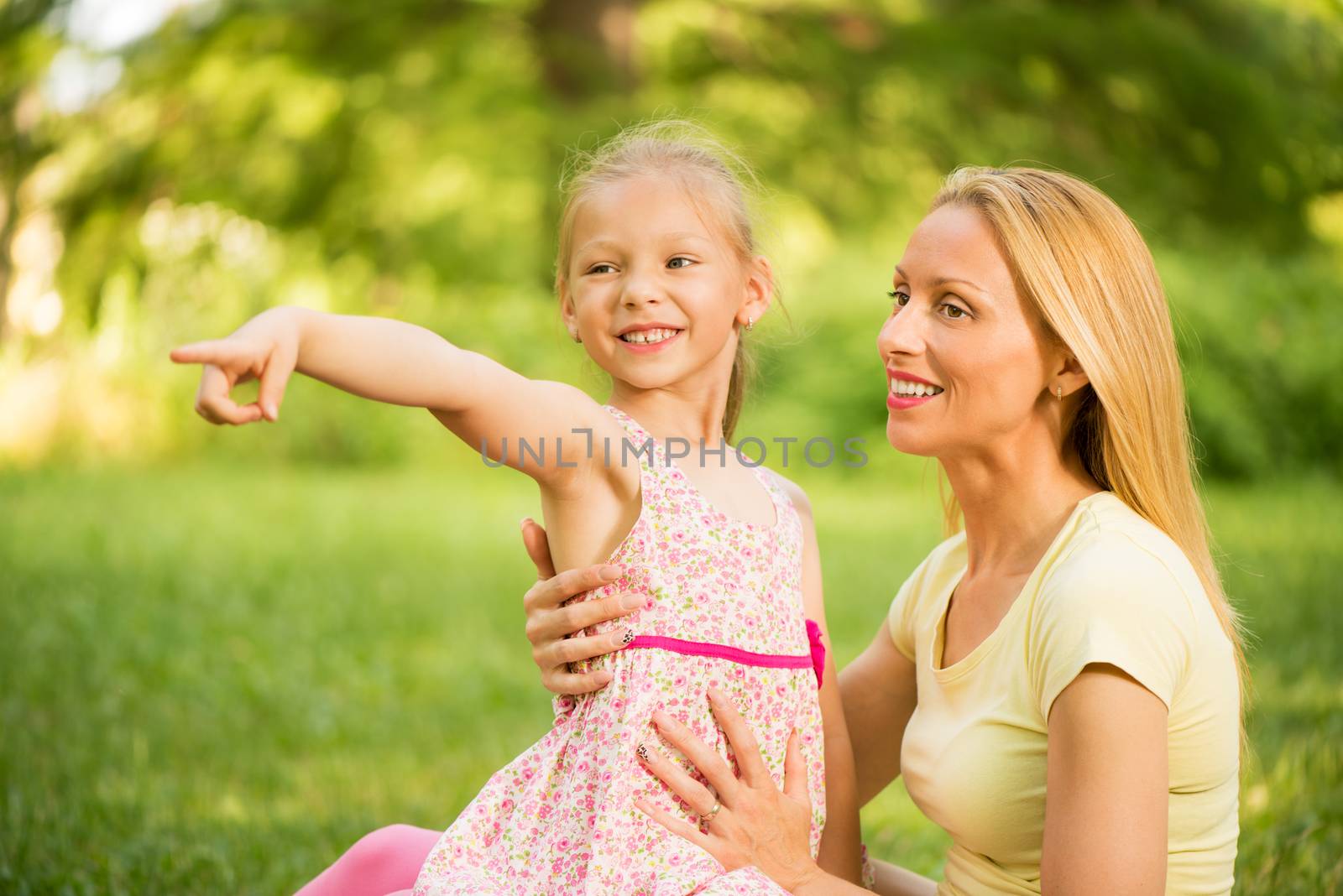 Happy cute little girl with mother in the park