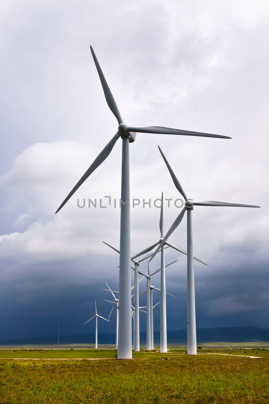 Wind turbines generating electricity in a stormy weather.