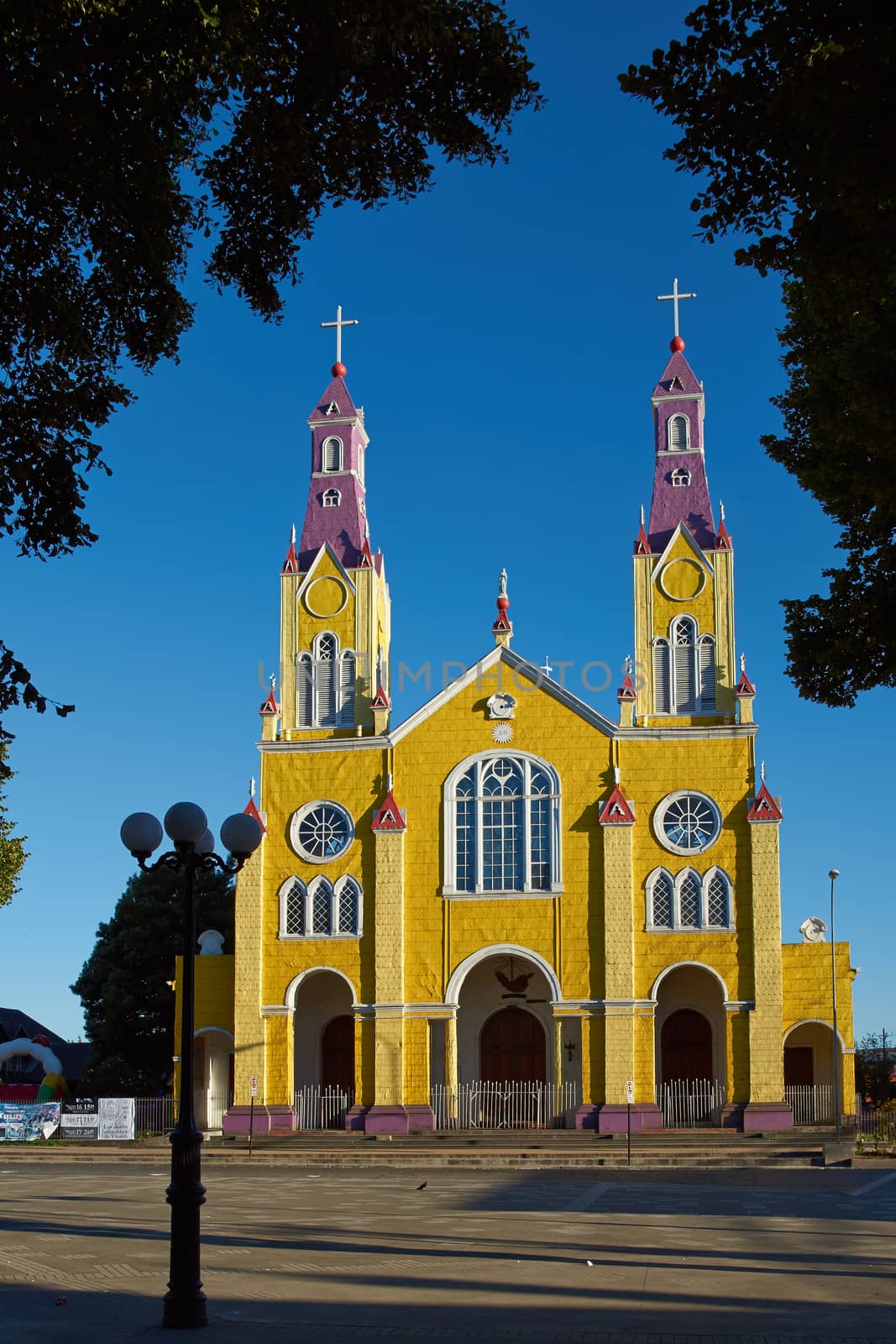 Bright yellow and purple painted facade of the historic Iglesia San Francisco in Castro, capital of the island of Chiloé in Chile.