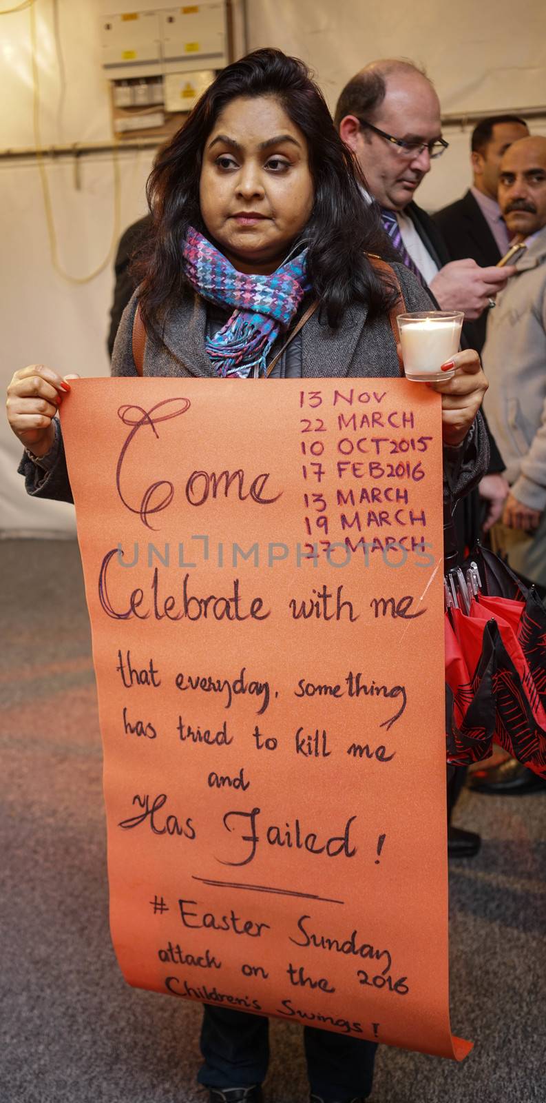 UK, London: A woman holds a sign during a candlelight vigil at the Pakistan High Commission in London on March 29, 2016. The gathering honors the victims of the terrorist attack that left at least 72 dead in Lahore, Pakistan on Easter Sunday. Jamaat-ul-Ahrar, a splinter group of the Taliban, claimed responsibility for the attack.