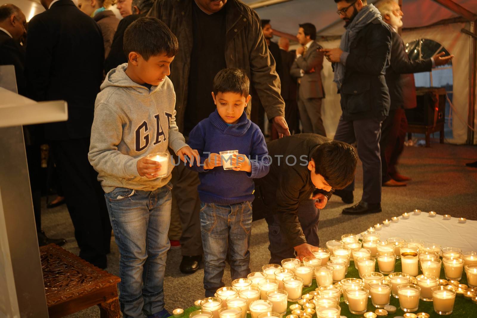 UK, London: Children place candles during a vigil at the Pakistan High Commission in London on March 29, 2016. The gathering honors the victims of the terrorist attack that left at least 72 dead in Lahore, Pakistan on Easter Sunday. Jamaat-ul-Ahrar, a splinter group of the Taliban, claimed responsibility for the attack.