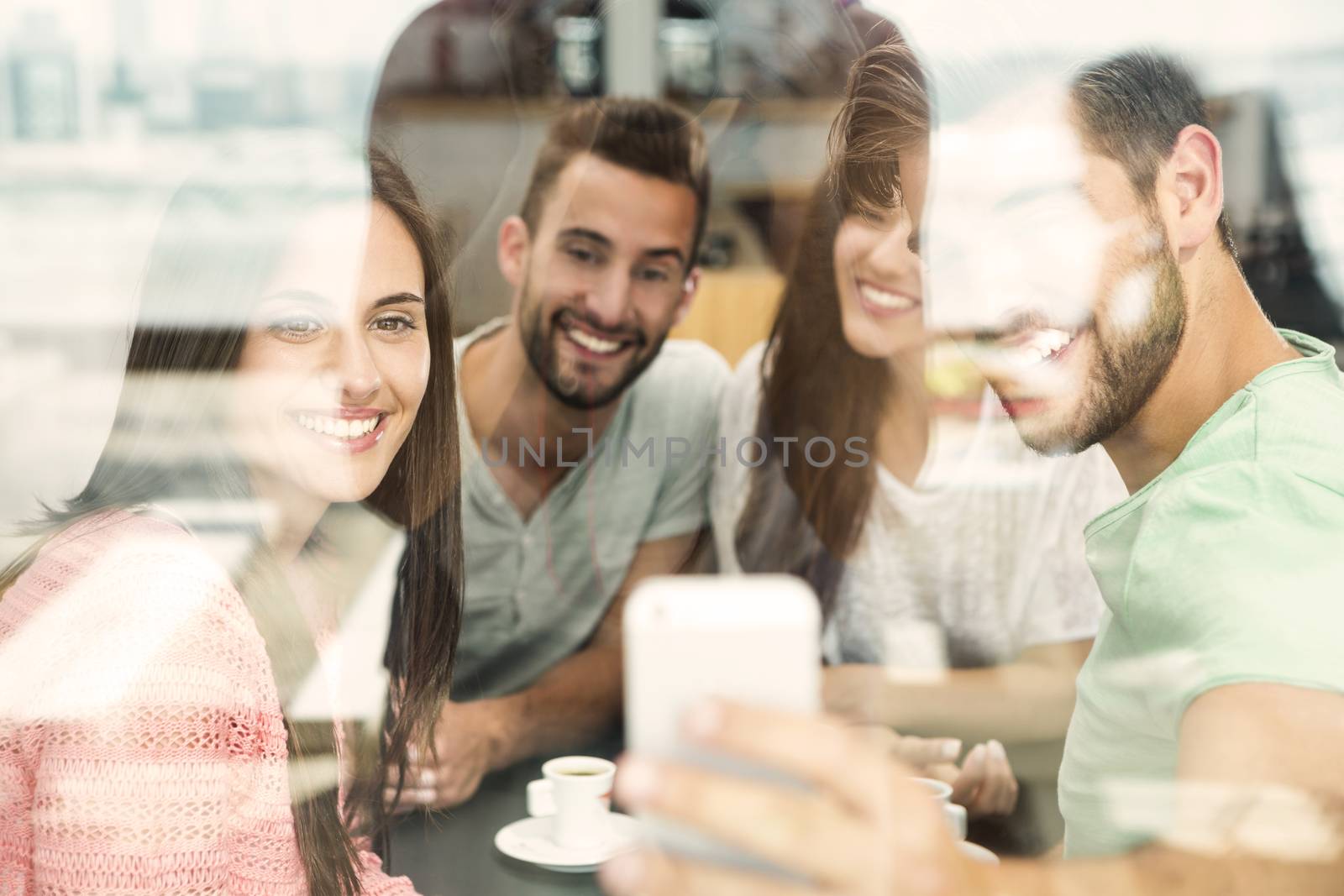 Group of friends at the coffee shop making a selfie together 
