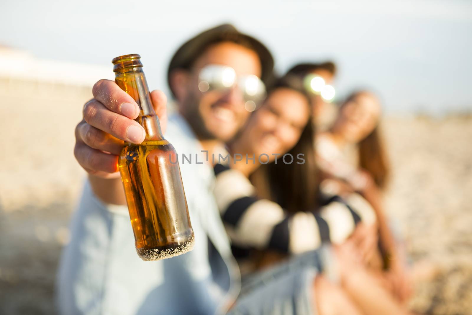 Group of friends at the beach having fun