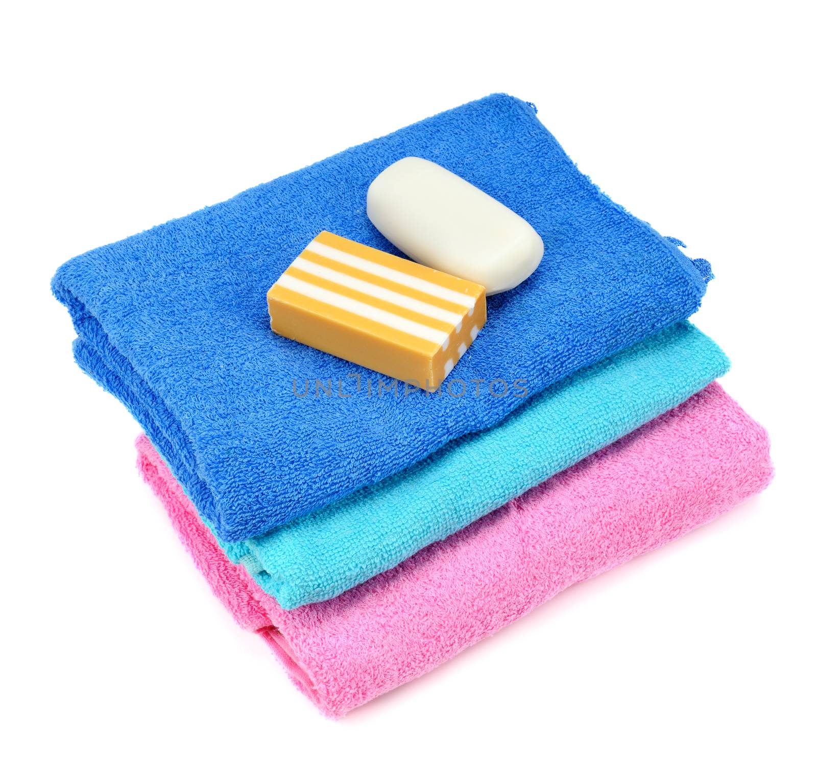 Stack of towels and soap isolated on white background