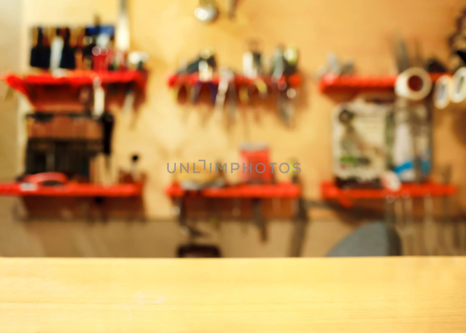 Tools on the wall in the workshop, blurred background.