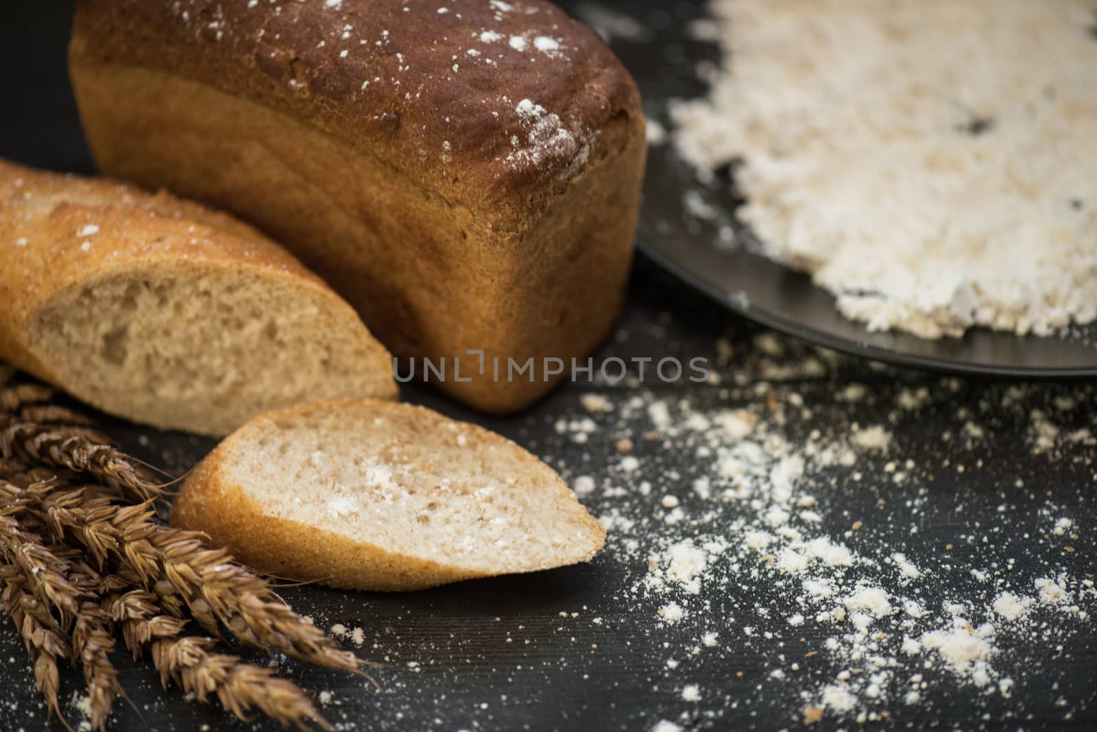 Bread composition with wheats. Very shallow DOF photo and specific art curly bokeh for extra volume.