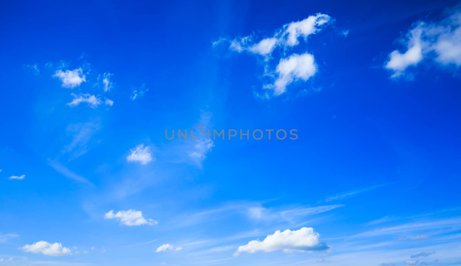 blue sky with small clouds by maxlindna