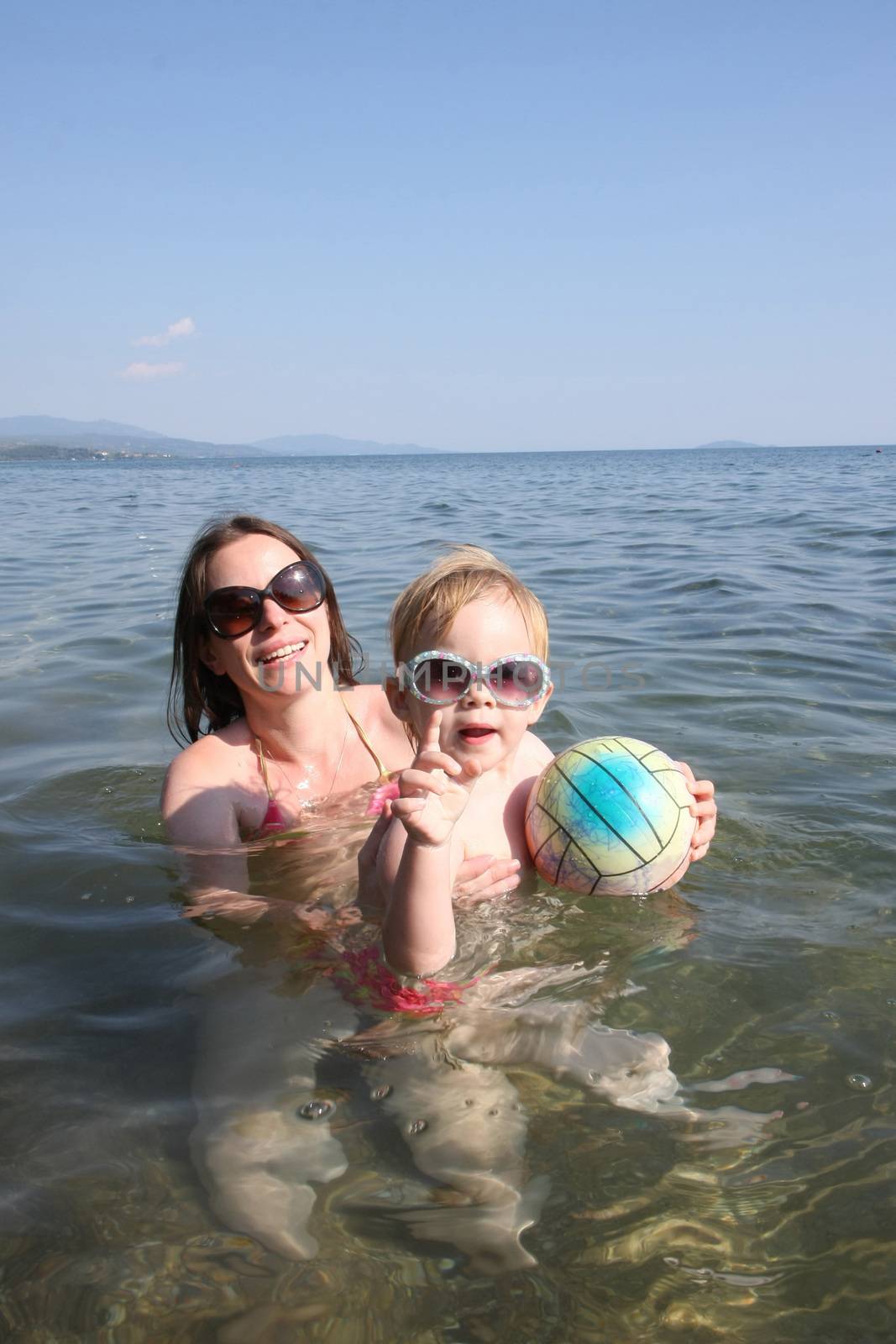 Mother and daughter enjoying  in the sea water