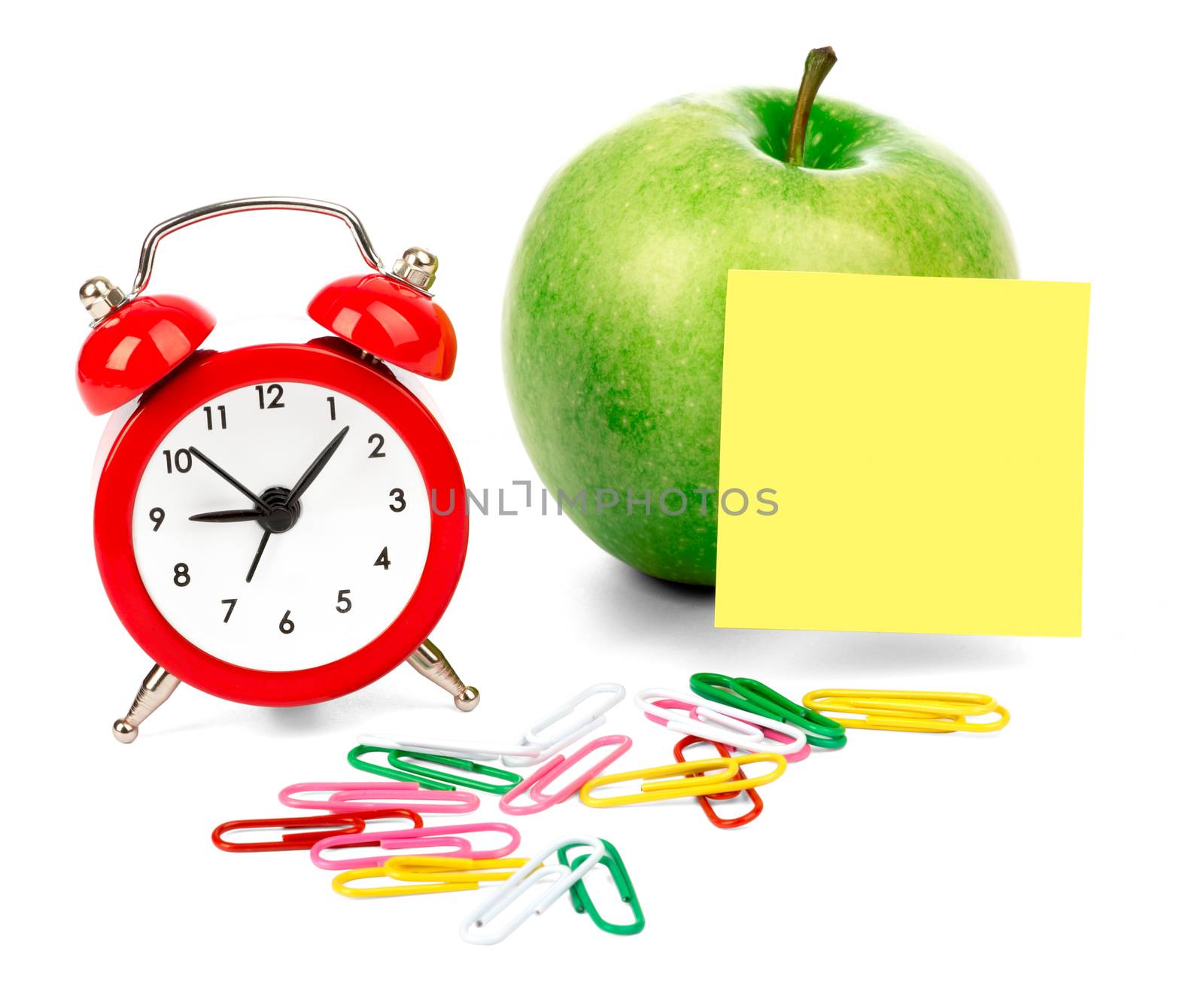 Alarm clock with apple and clips isolated on white background