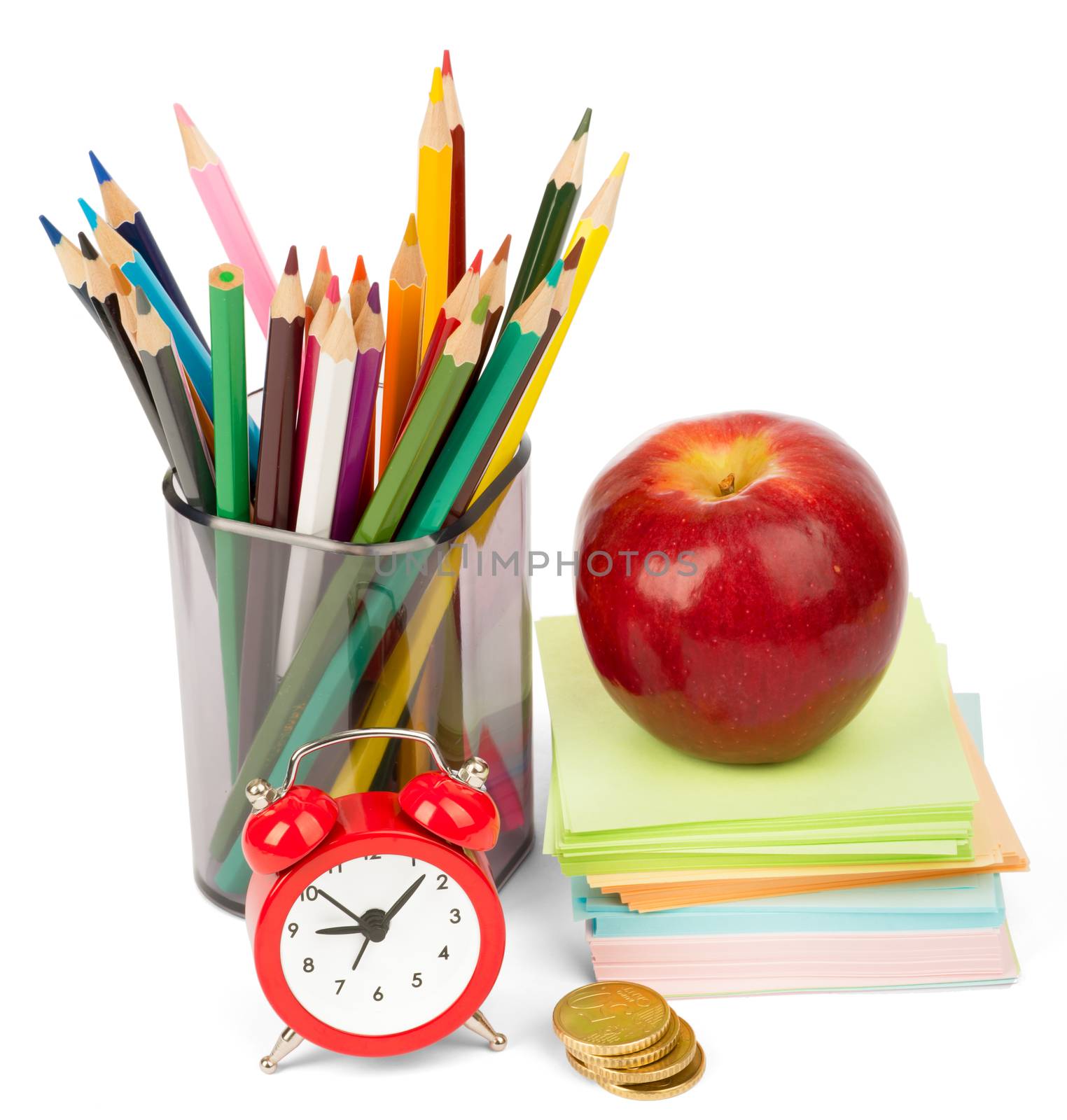 Alarm clock with red apple and crayons isolated on white background