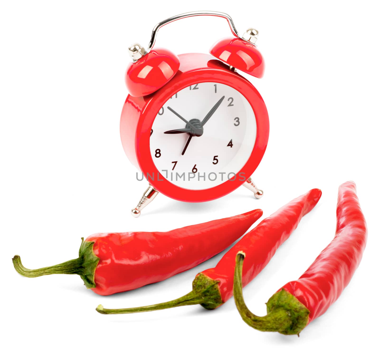 Red hot pepper with alarm clock on isolated white background, side view