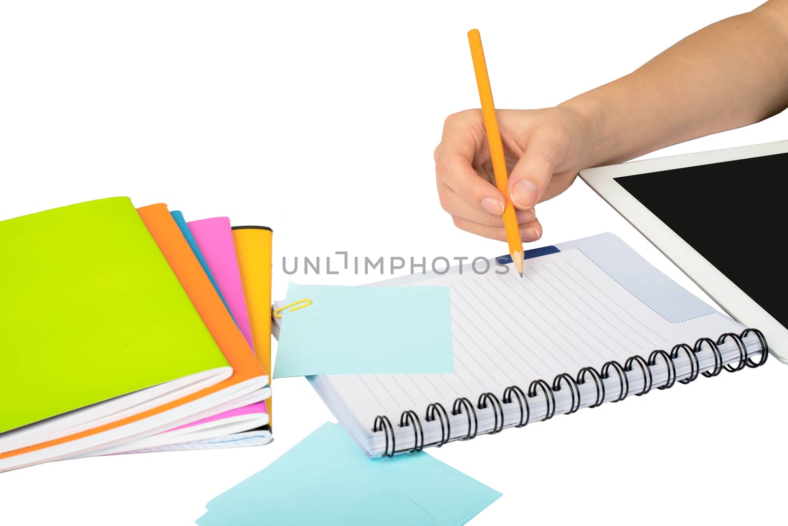 Females hand writing in notebook with tablet on isolated white background